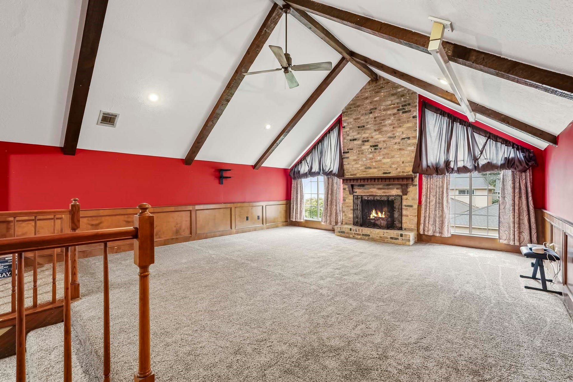 3610 Valley Haven Drive, Houston, TX 77339 Expansive game room with vaulted ceilings, exposed beams, and a striking brick fireplace, complemented by large windows for natural light.