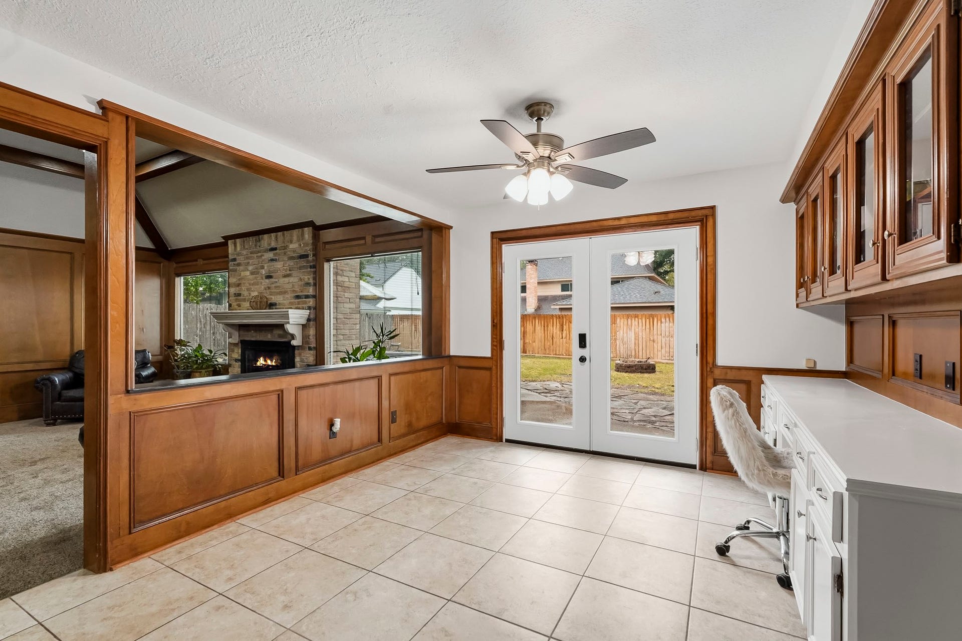3610 Valley Haven Drive, Houston, TX 77339 Bright and inviting space featuring elegant wood paneling and built-in cabinetry, with French doors leading to the backyard.