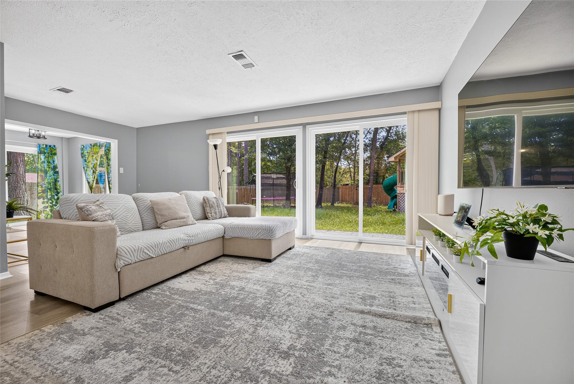 1610 N Red Cedar Circle, The Woodlands, TX 77380 Living room - sliding double pane glass doors open to backyard