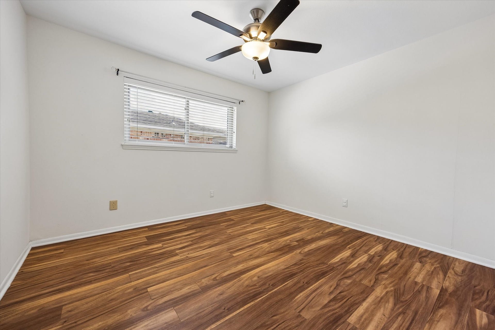 10831 Olympia Drive, Houston, TX 77042 Another guest bedroom featuring durable wood-look laminate flooring and a ceiling fan. No carpet in this home!