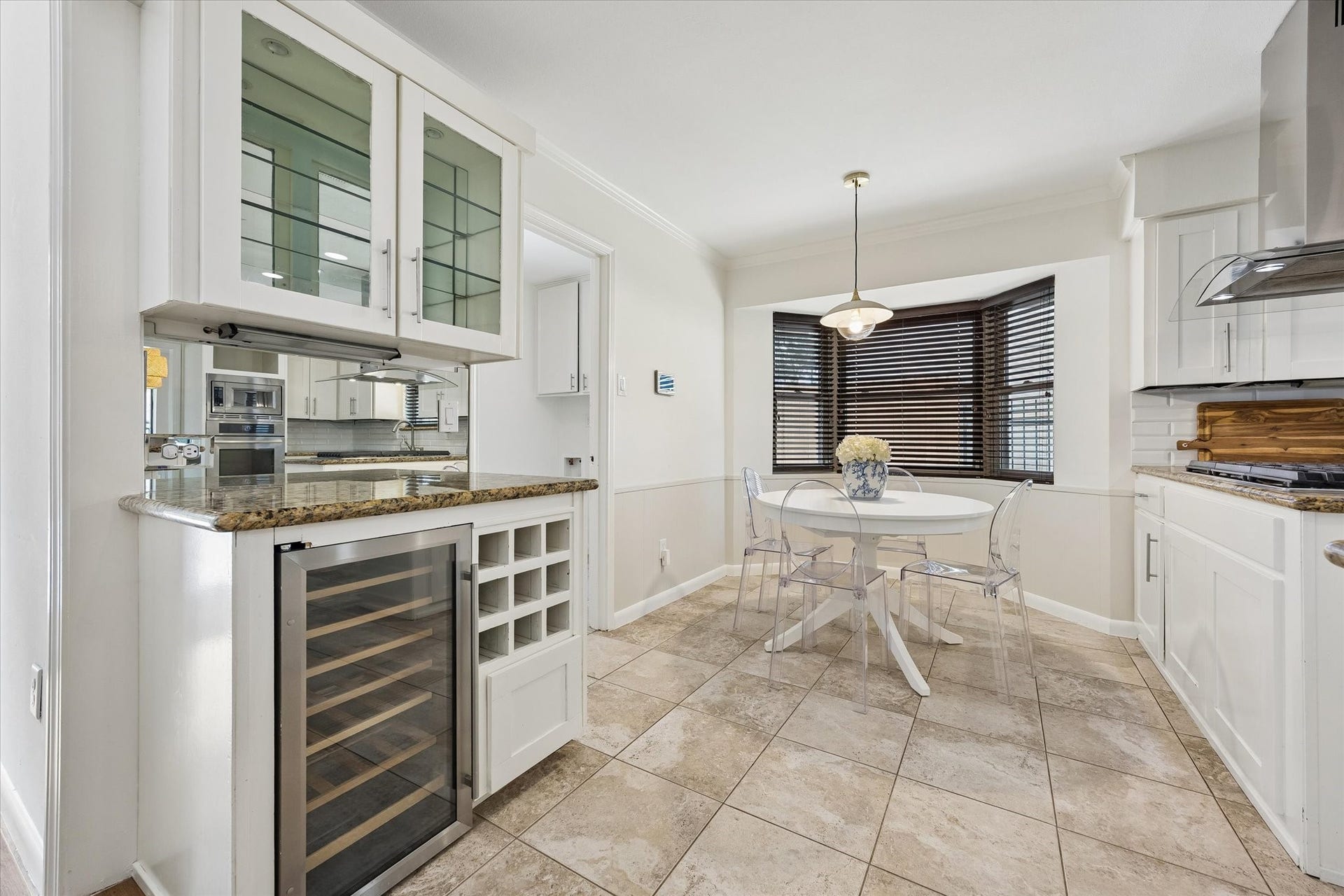 10831 Olympia Drive, Houston, TX 77042 Tucked just off the kitchen, the charming breakfast room features a built-in dry bar complete with a wine fridge and glass-front cabinetryan ideal spot for organizing your glassware and favorite pieces.