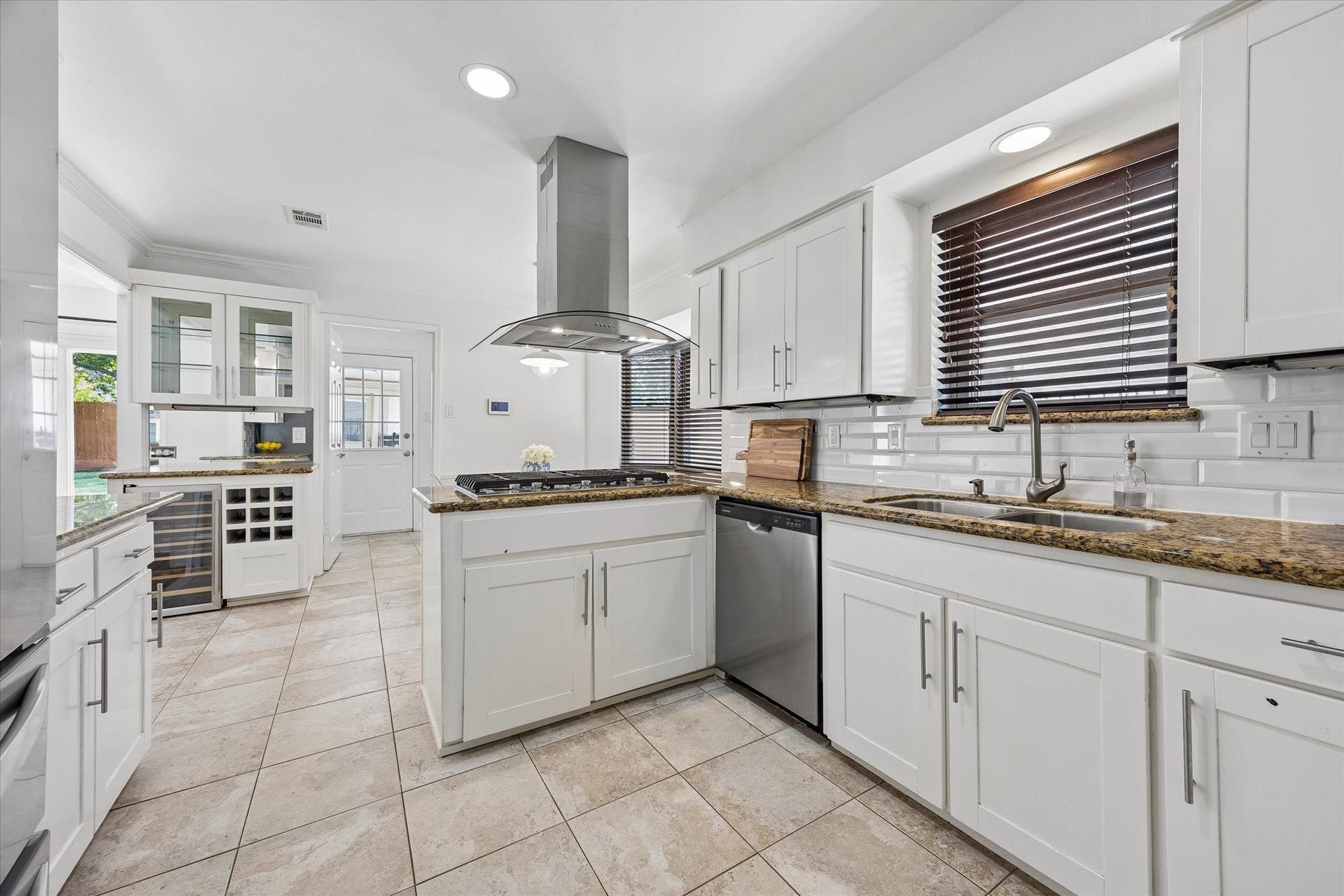 10831 Olympia Drive, Houston, TX 77042 Kitchen is equipped with stainless steel appliances including Kitchenaid gas stove top and Jenn-Air convection oven.