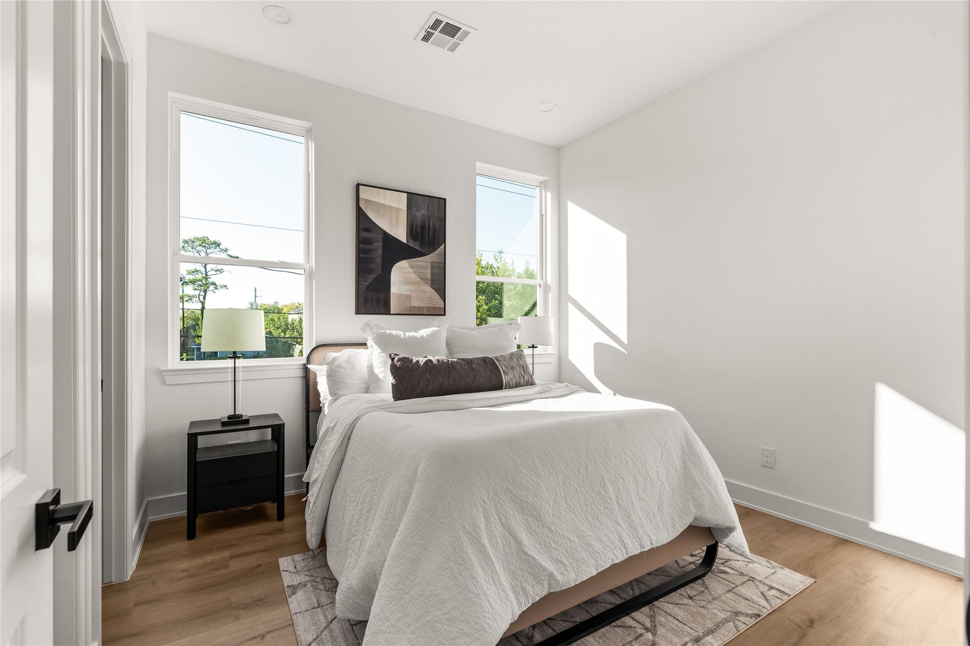 6714 Tierwester Street, Houston, TX 77021 Sunlight pours through a pair of generously sized windows, lending an airy quality to this secondary bedroom.