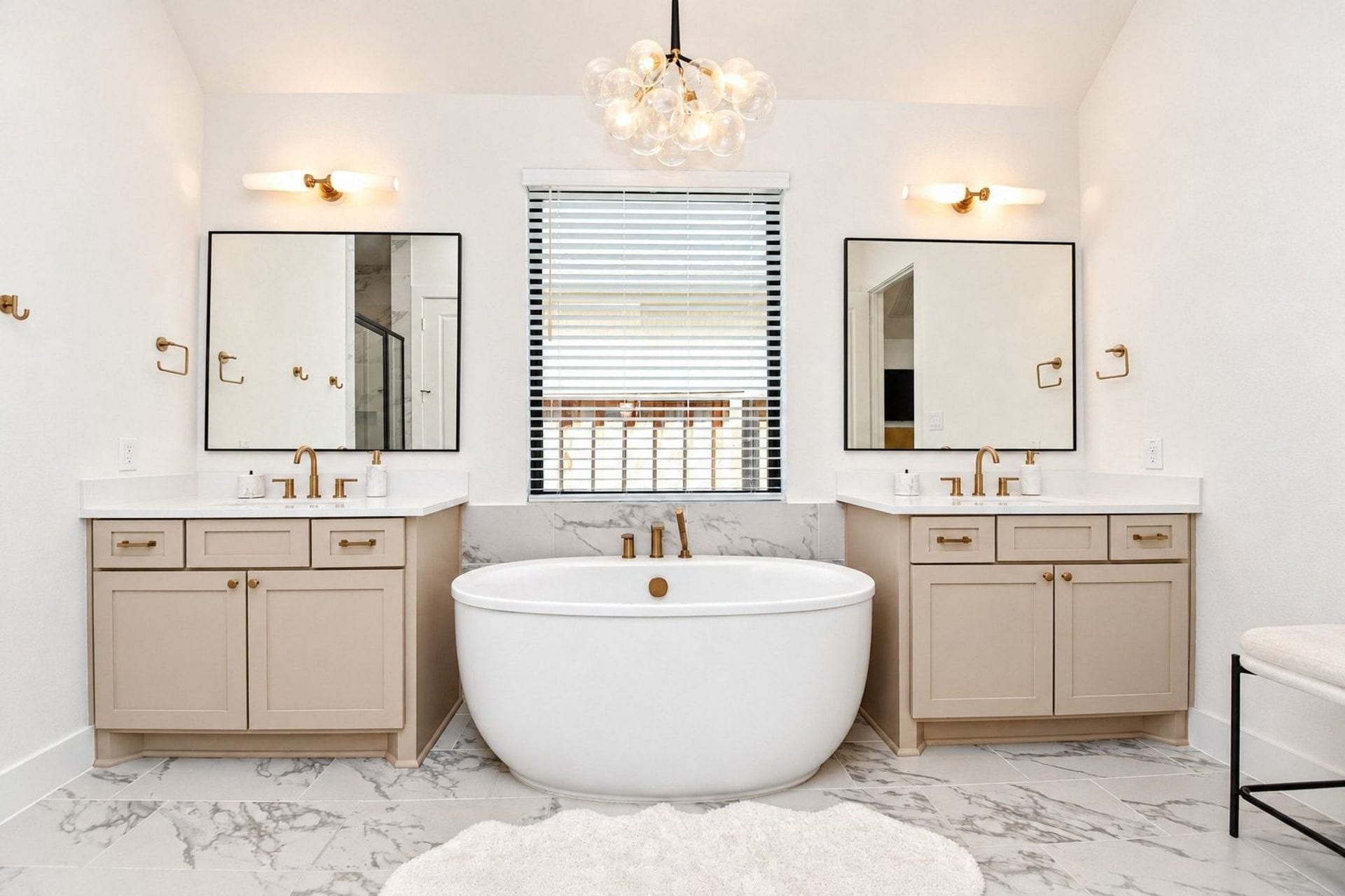 20222 Palomar Pointe Drive, Cypress, TX 77433 Luxurious bathroom featuring a freestanding soaking tub, dual vanities with elegant gold fixtures, and chic lighting, all complemented by marble like flooring and modern accents.