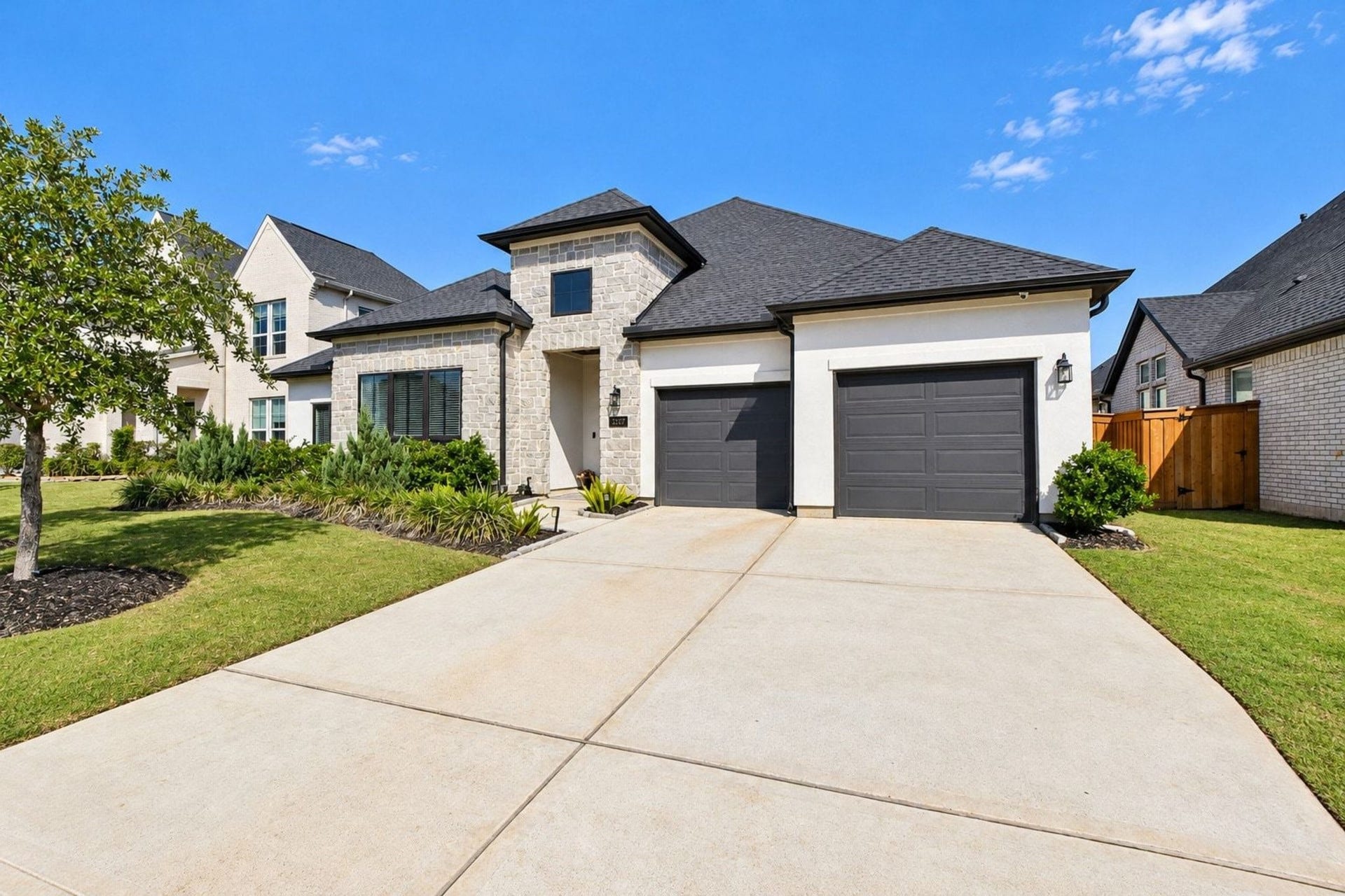 20222 Palomar Pointe Drive, Cypress, TX 77433 Stunning modern home with a sleek facade, featuring two spacious garages and manicured landscaping, set in a desirable neighborhood.