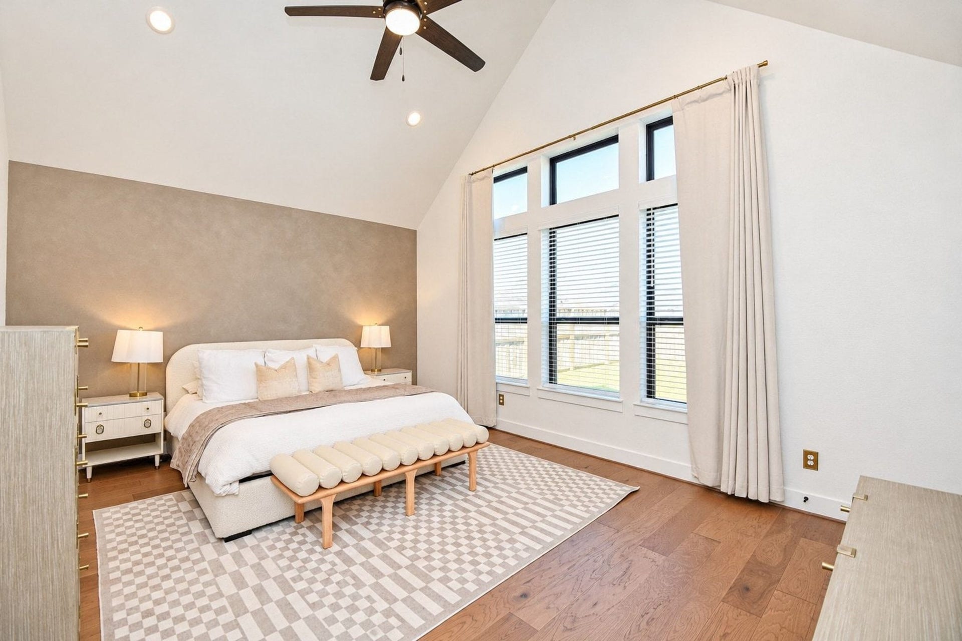 20222 Palomar Pointe Drive, Cypress, TX 77433 Spacious bedroom with vaulted ceilings, abundant natural light from large windows, and elegant neutral decor for a serene retreat.