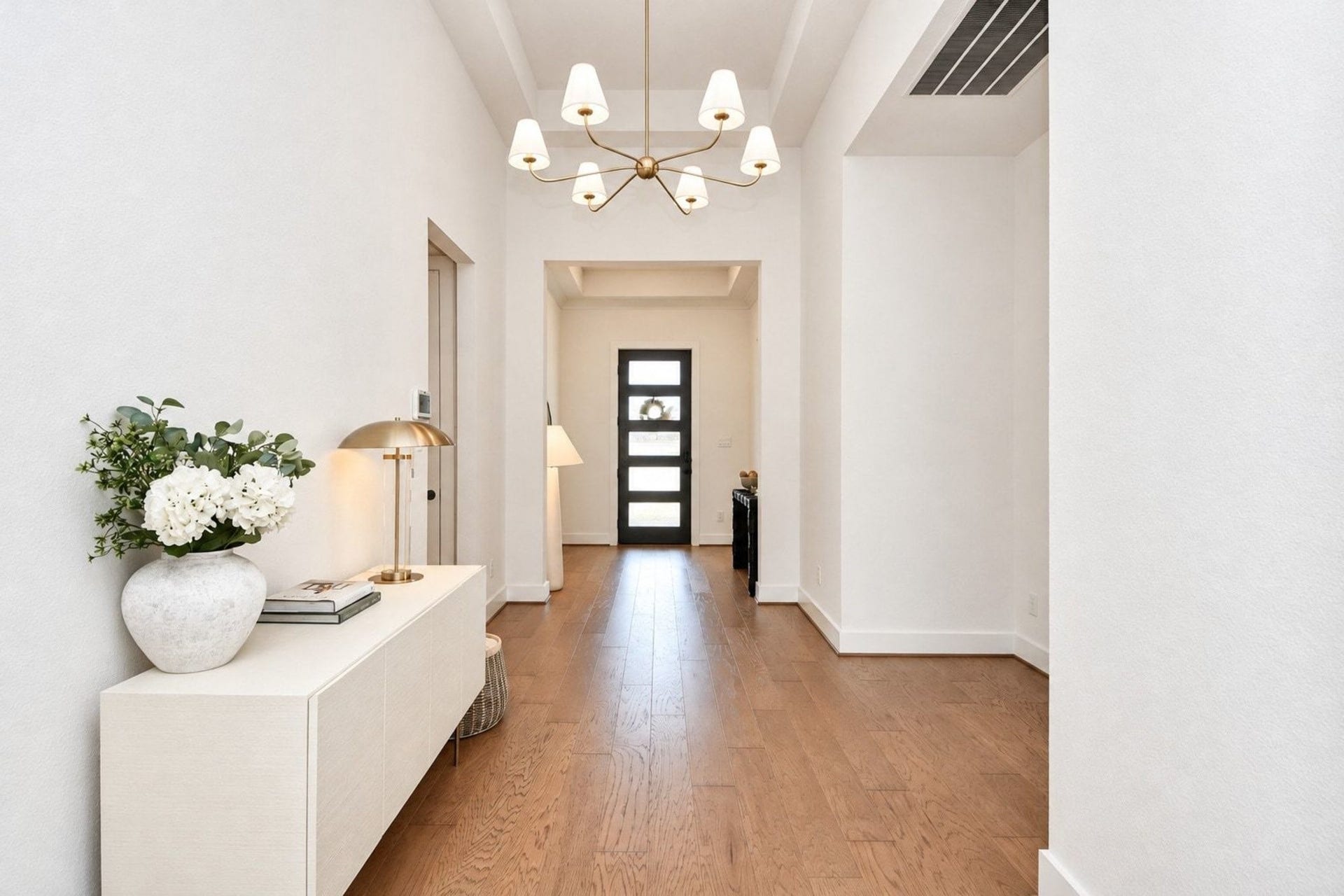 20222 Palomar Pointe Drive, Cypress, TX 77433 Dramatic and spacious entryway featuring a modern chandelier and hardwood floors.