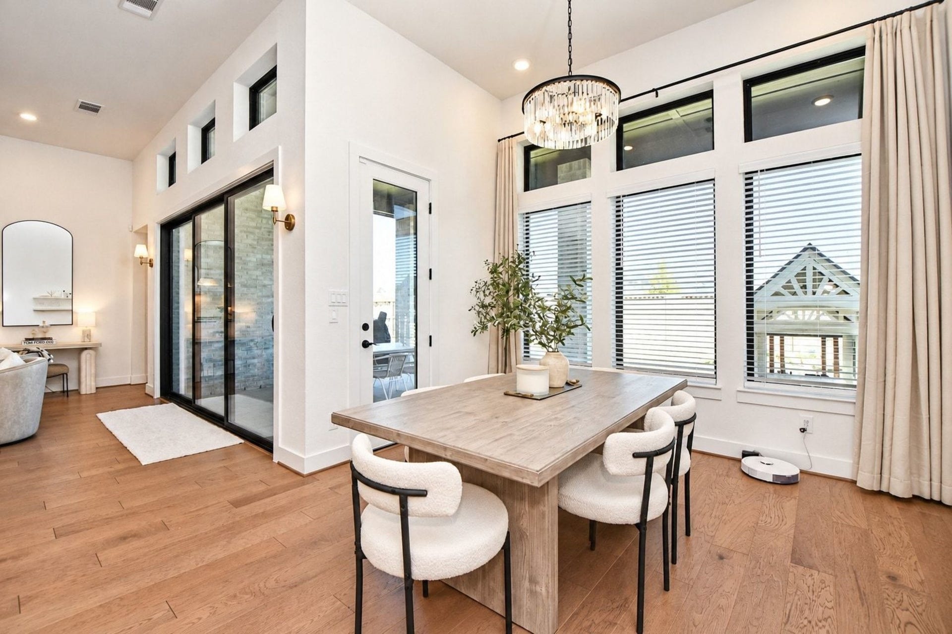 20222 Palomar Pointe Drive, Cypress, TX 77433 Bright and airy dining area featuring large windows, high ceilings, elegant chandelier, and a seamless flow into the living space.