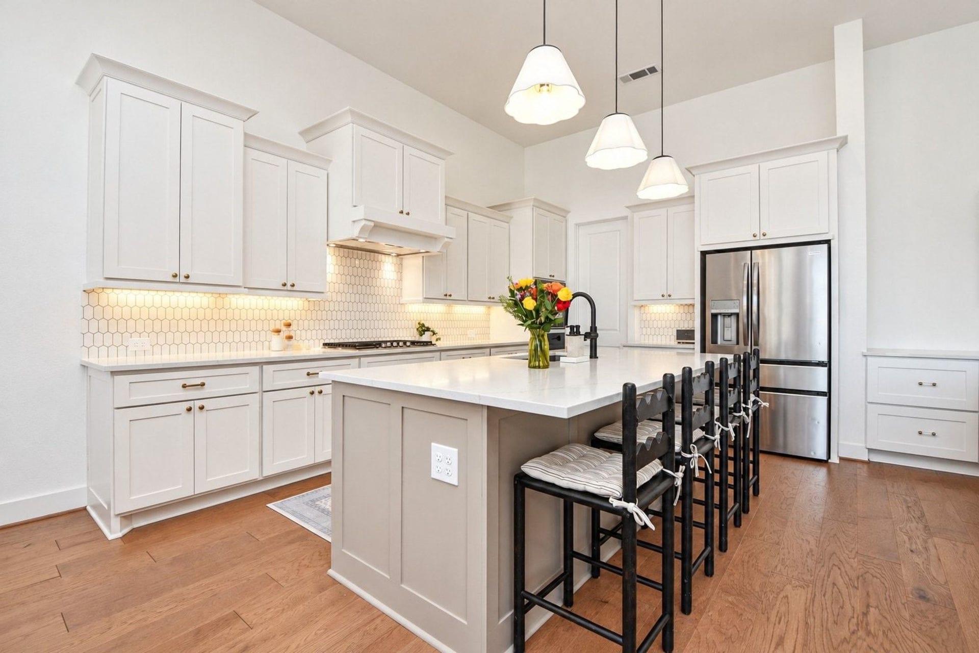 20222 Palomar Pointe Drive, Cypress, TX 77433 Bright and spacious kitchen with sleek white cabinetry, modern stainless steel appliances, and a large island with seating, perfect for entertaining and meal prep.