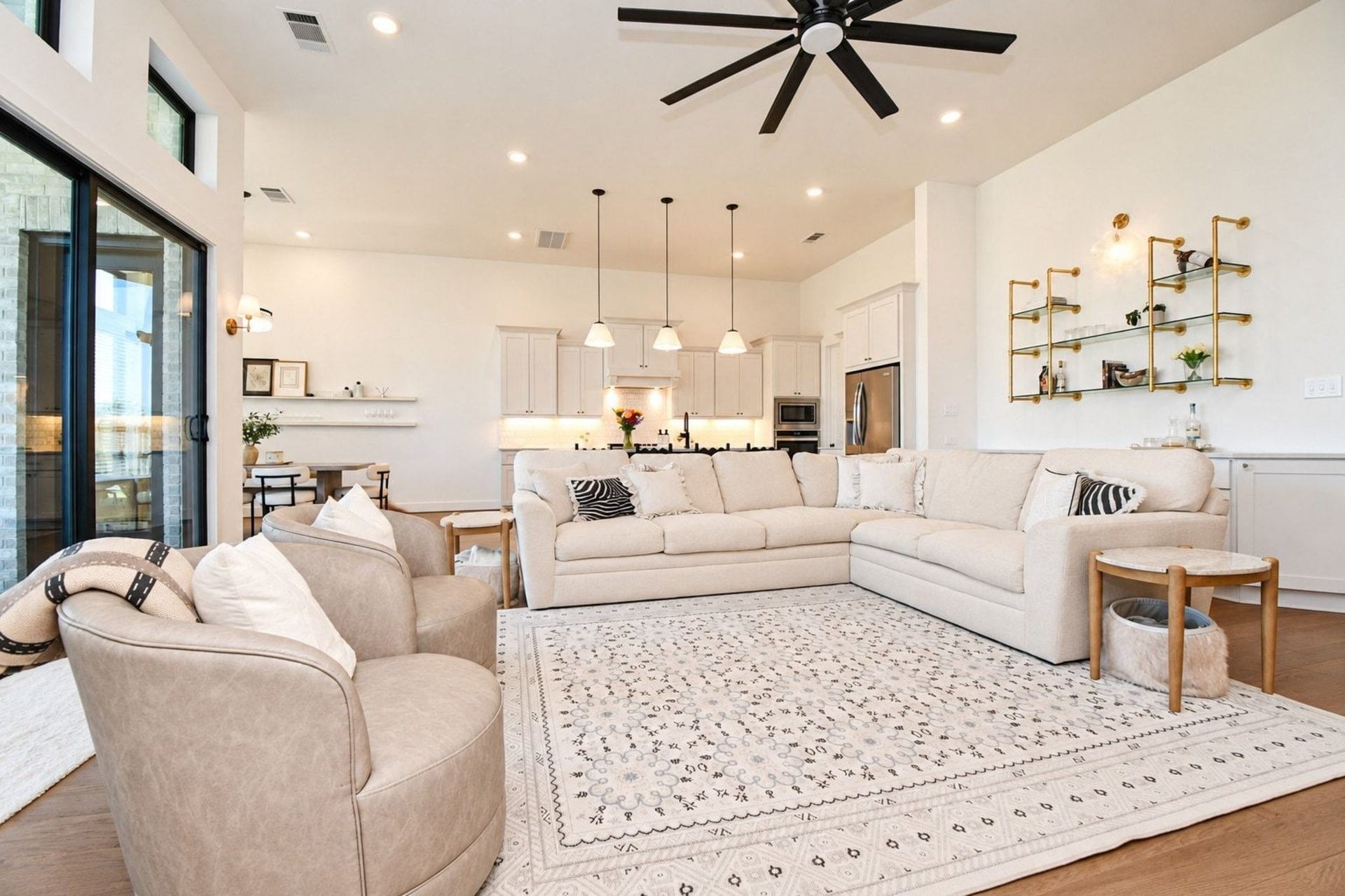 20222 Palomar Pointe Drive, Cypress, TX 77433 Open living area that seamlessly connected to a sleek kitchen with pendant lighting and stainless steel appliances.