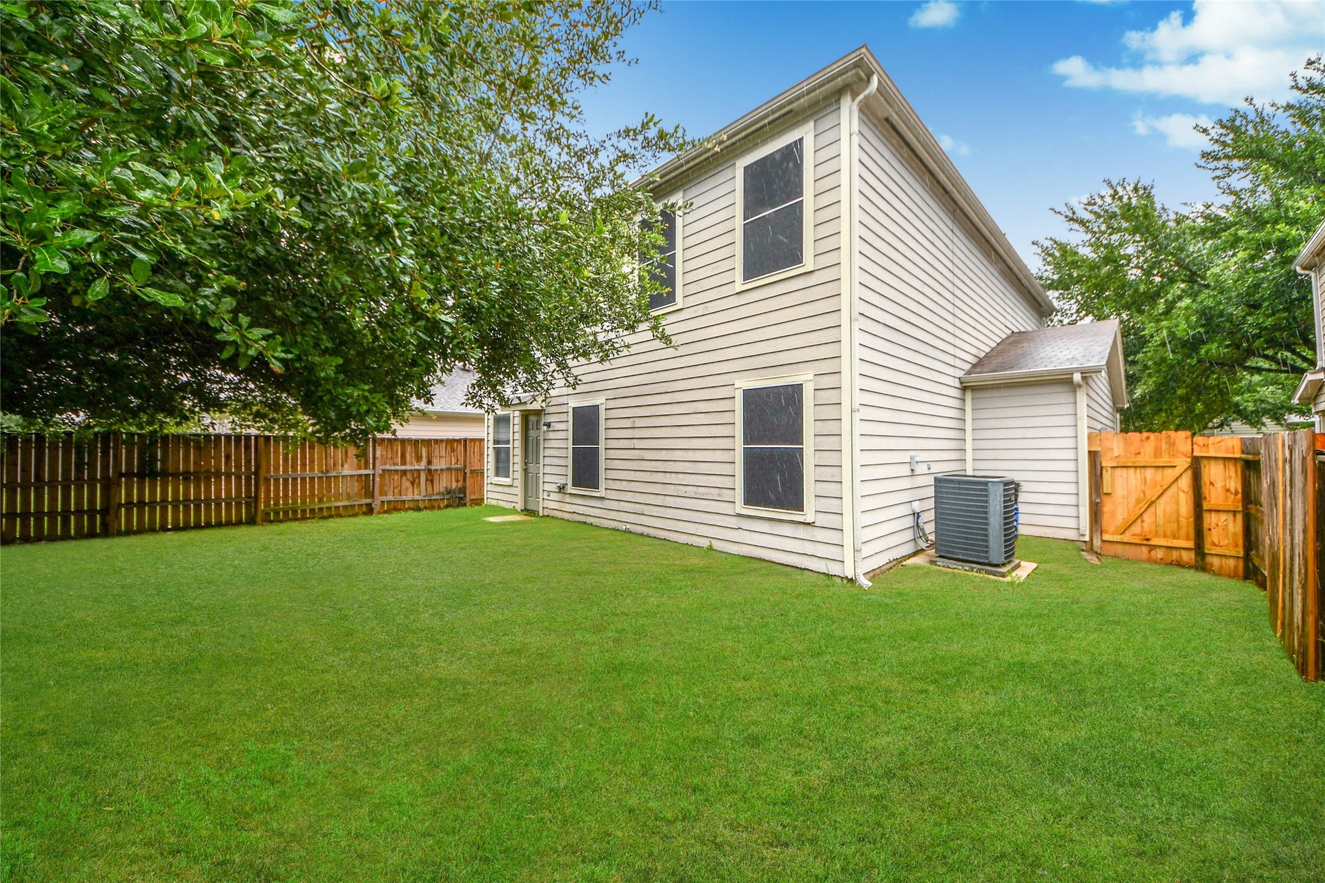 Expansive and lush, this backyard offers a perfect canvas for outdoor entertainment and relaxation.