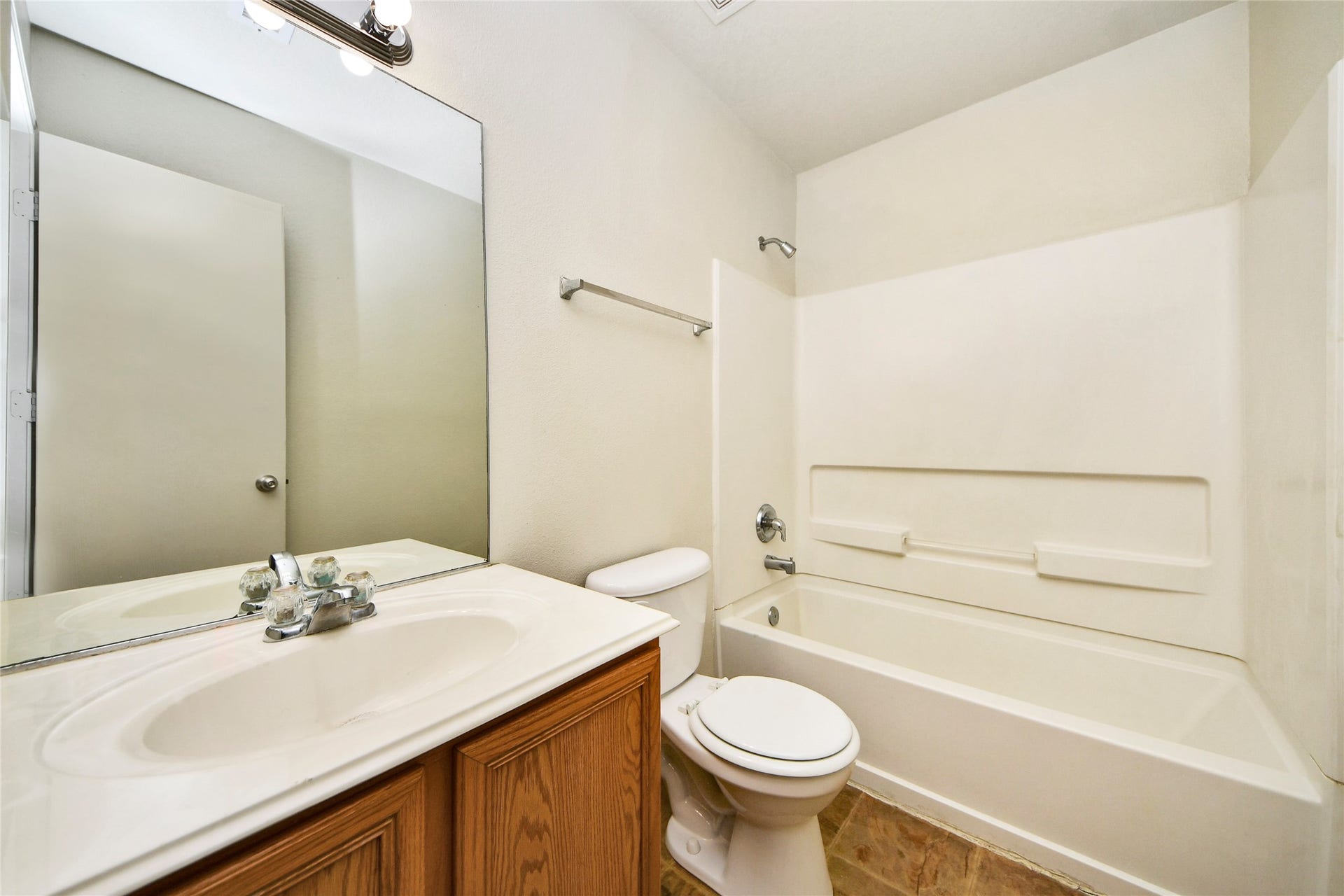 Sleek and functional, the second bathroom features a clean design with a spacious vanity and a full bathtub, offering everyday convenience and style.