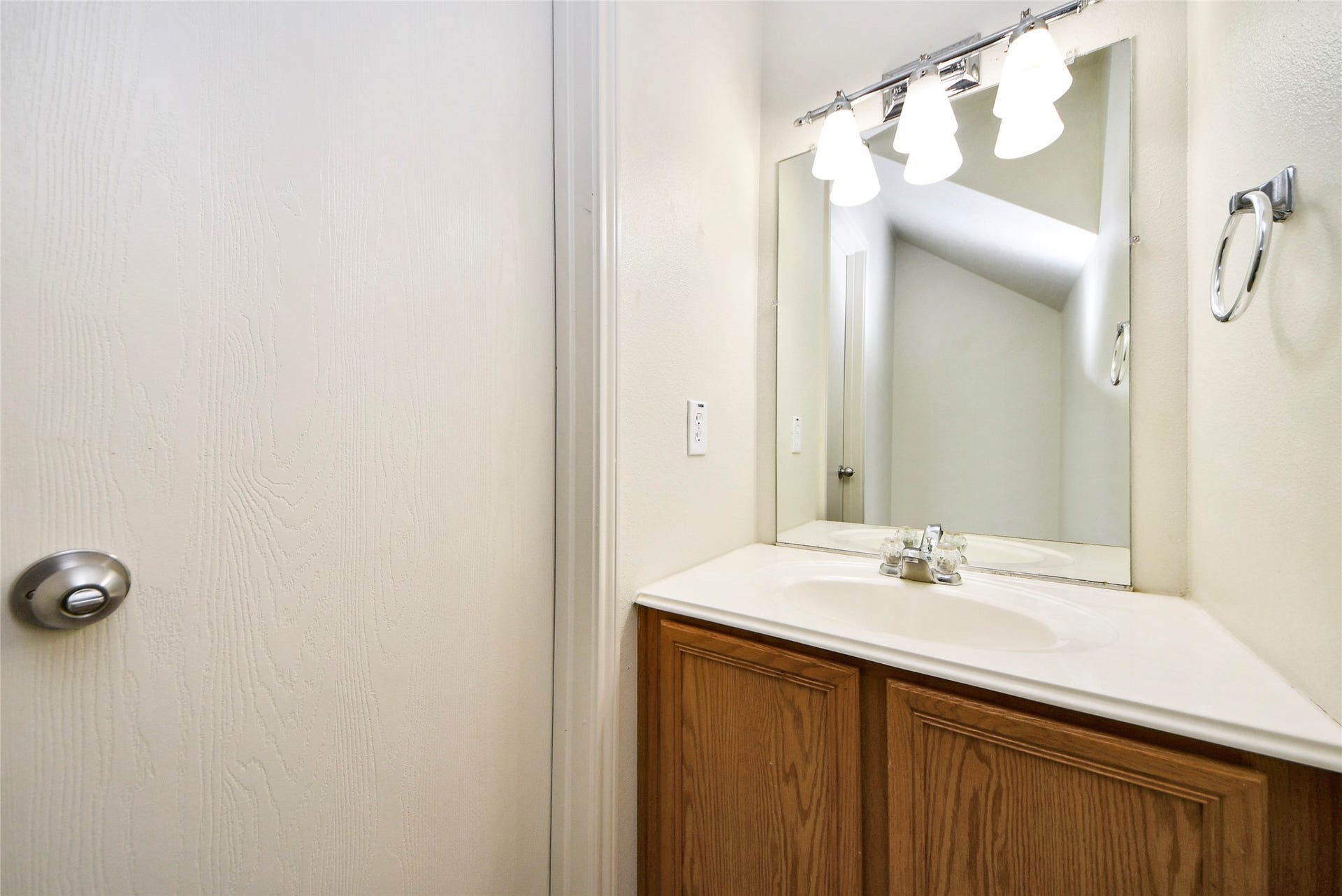 Conveniently located on the first floor, this sleek half bath offers modern fixtures and ample lighting for a stylish touch.