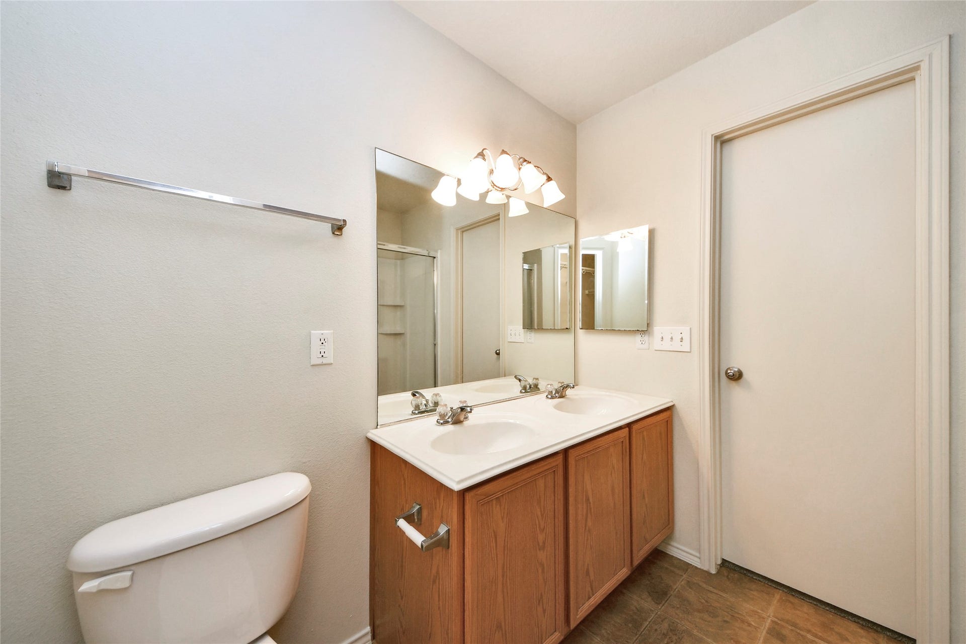 Experience the elegance of the primary bathroom, featuring a sleek double vanity, ample lighting, and a contemporary design perfect for relaxation.