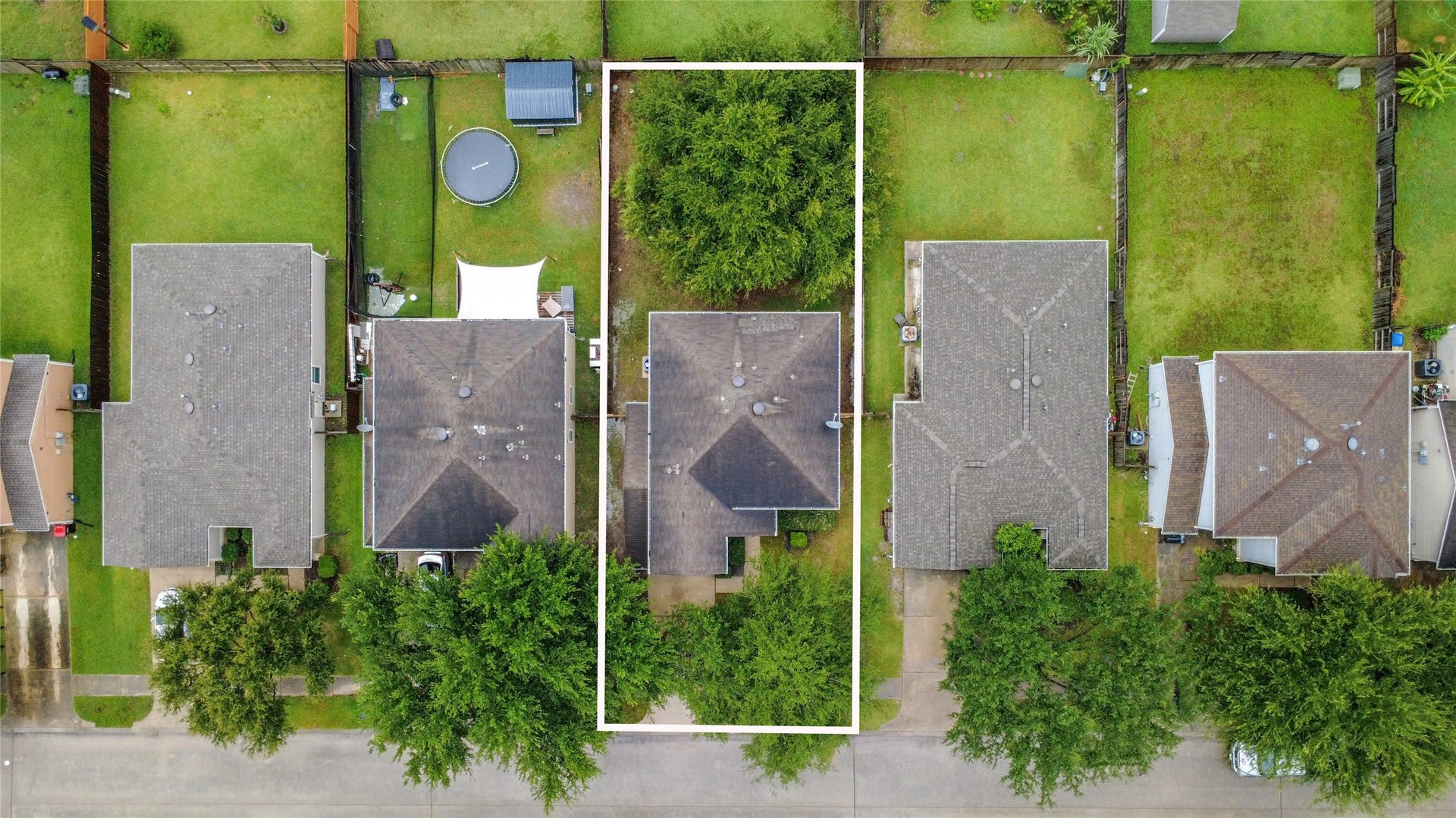 Charming home with a spacious backyard, nestled in a serene neighborhood, offering privacy with lush greenery and ample outdoor space for entertaining or relaxation.