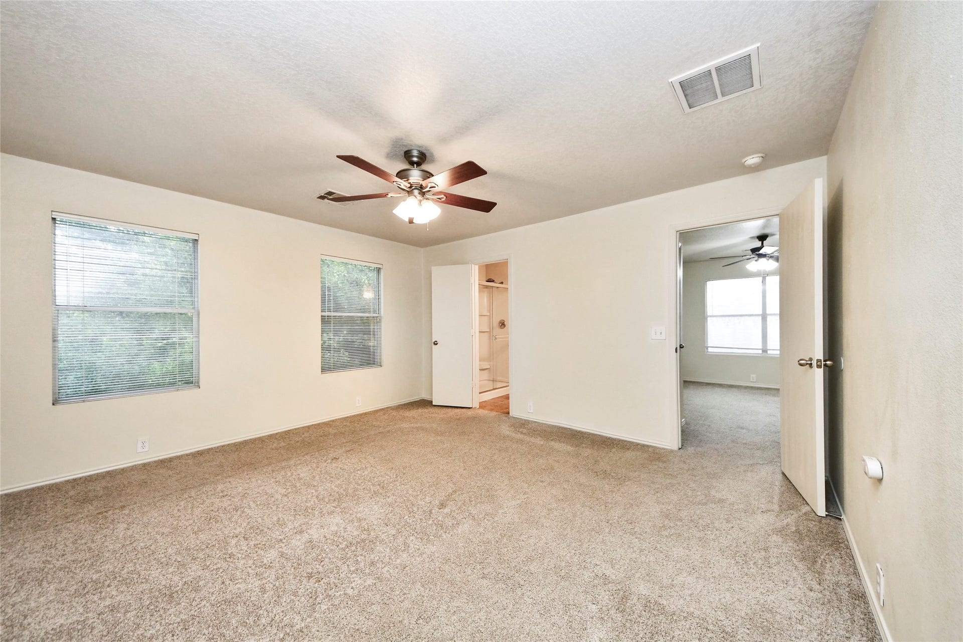 Spacious and inviting, the primary bedroom on the second floor offers ample natural light and cozy carpeting, creating a serene retreat.