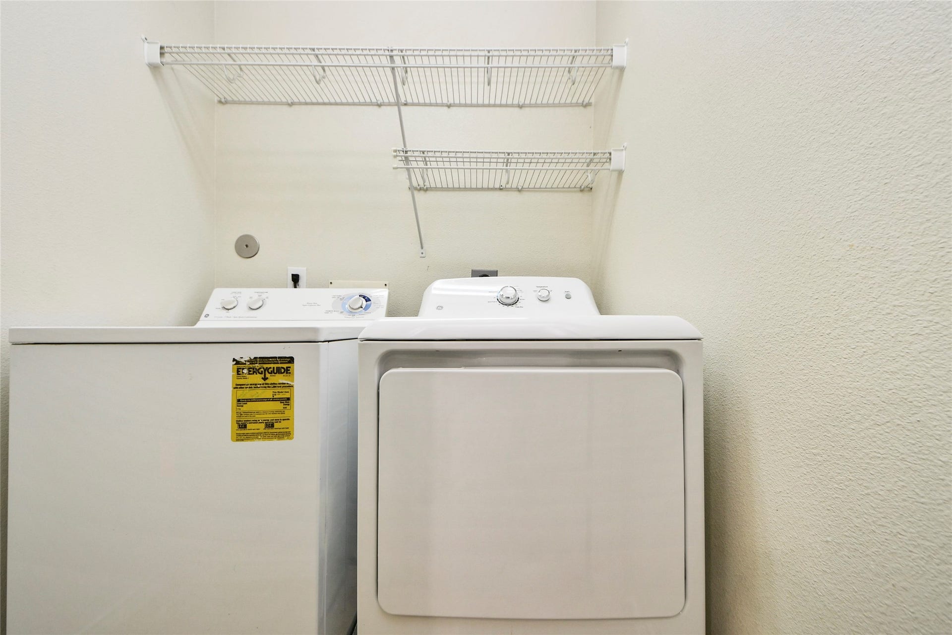 Conveniently located on the second floor, this utility room offers seamless laundry access with ample shelving for efficient organization.