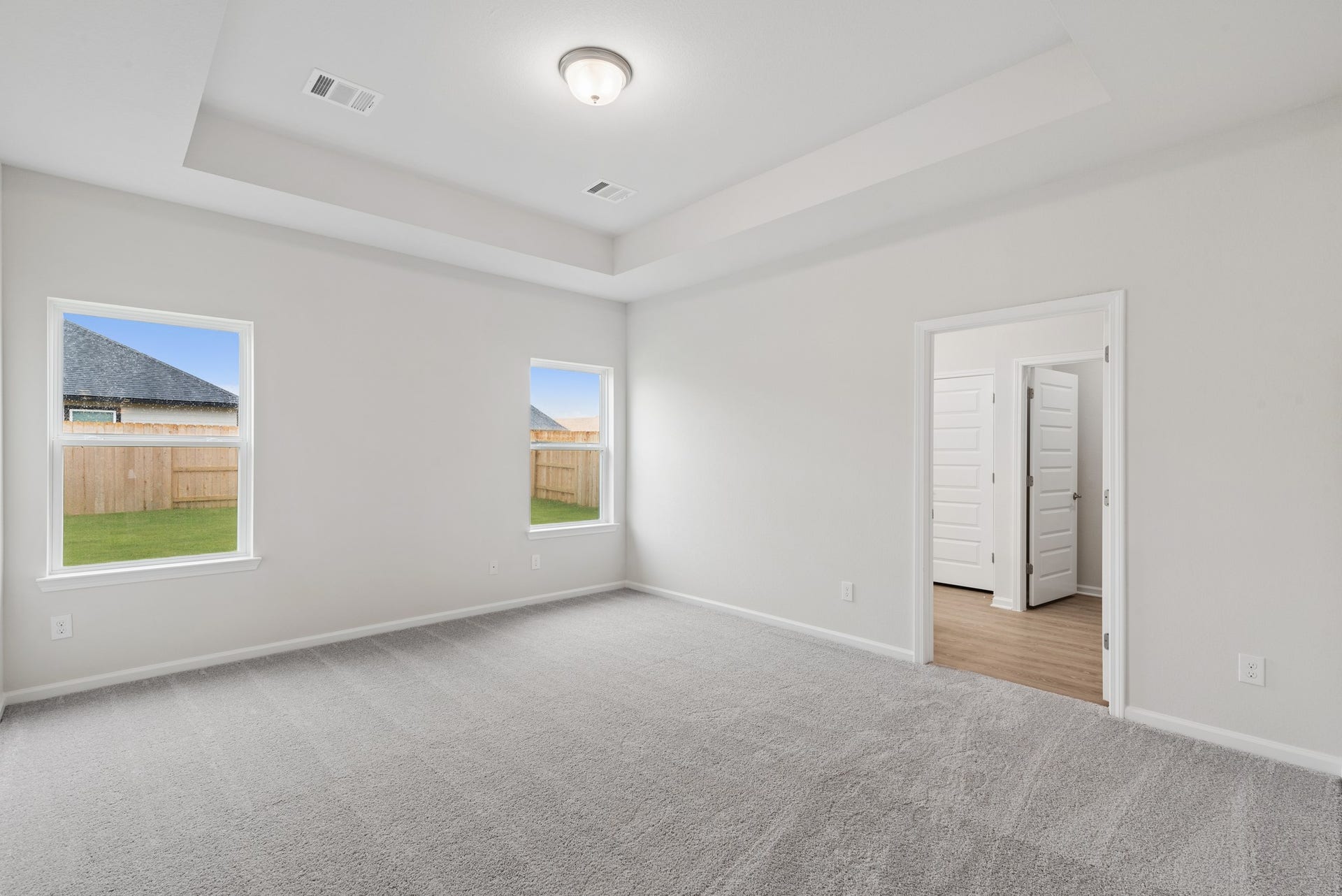 2518 Outpost Canyon Drive, Iowa Colony, TX 77583 The Oakshire II- Primary Bedroom with Tray Ceiling. Sample image for illustration; upgrades, options, and colors may vary.