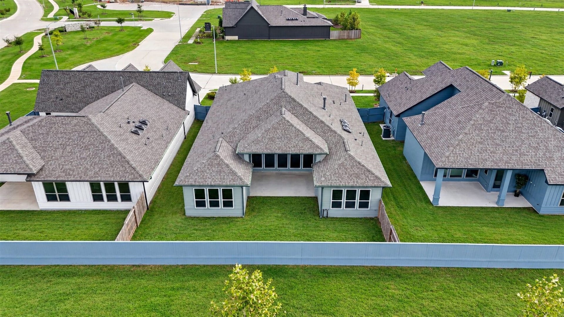 32506 Ebony Jewelwing Court, Fulshear, TX 77441 Rear Aerial / Backyard View
Impressive rear elevation showcasing the home's expansive single-story layout, generously sized backyard, and centrally positioned covered patio designed for outdoor living.