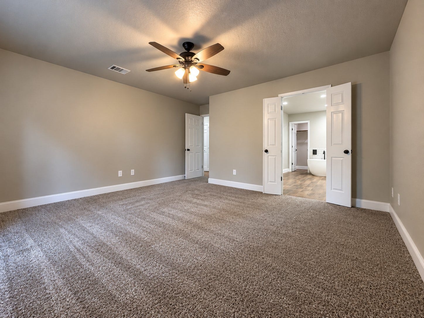 2102 Autumn Cove Drive, League City, TX 77573 Spacious primary bedroom with a private en-suite bathroom featuring a freestanding soaking tub and beautifully updated finishes.