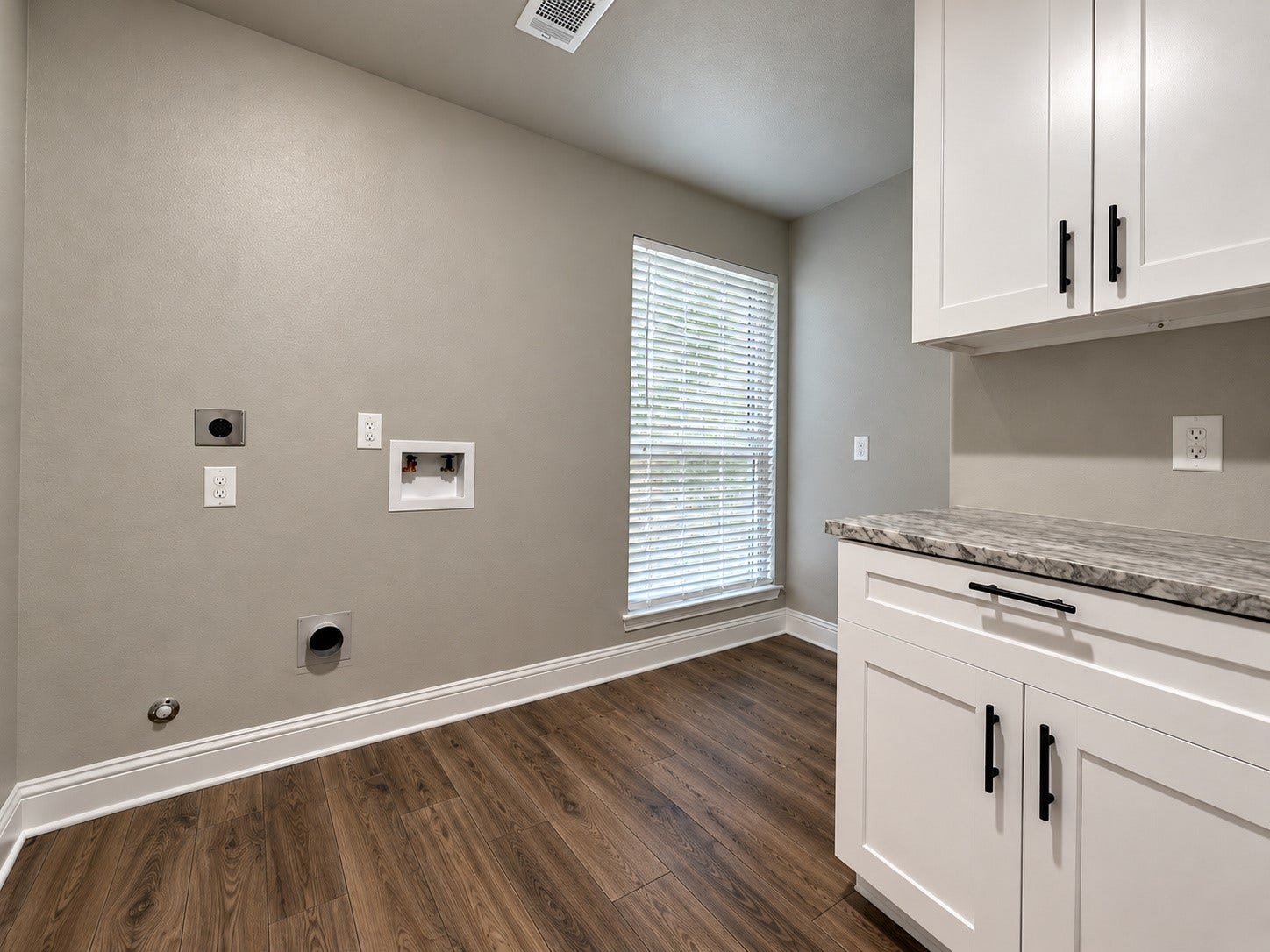 2102 Autumn Cove Drive, League City, TX 77573 Spacious laundry room with built-in cabinetry, countertop workspace, natural lighting, and room for an additional refrigerator or freezer.