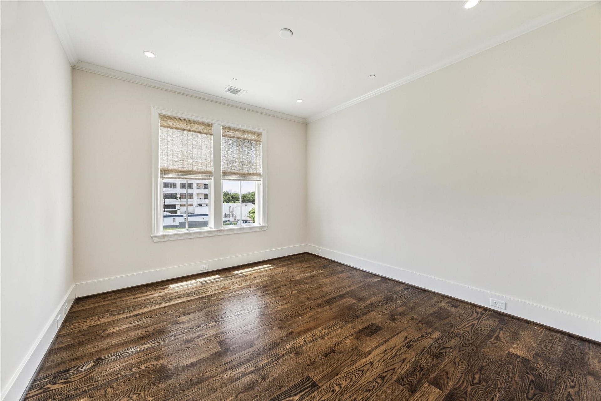 2413 Mimosa Drive, Houston, TX 77019 Just outside the primary bedroom is an additional room that gives the upper level valuable flexibility. With hardwood floors and natural light, it could become a private office, sitting room, nursery, fitness space, or quiet retreat connected to the primary suite.