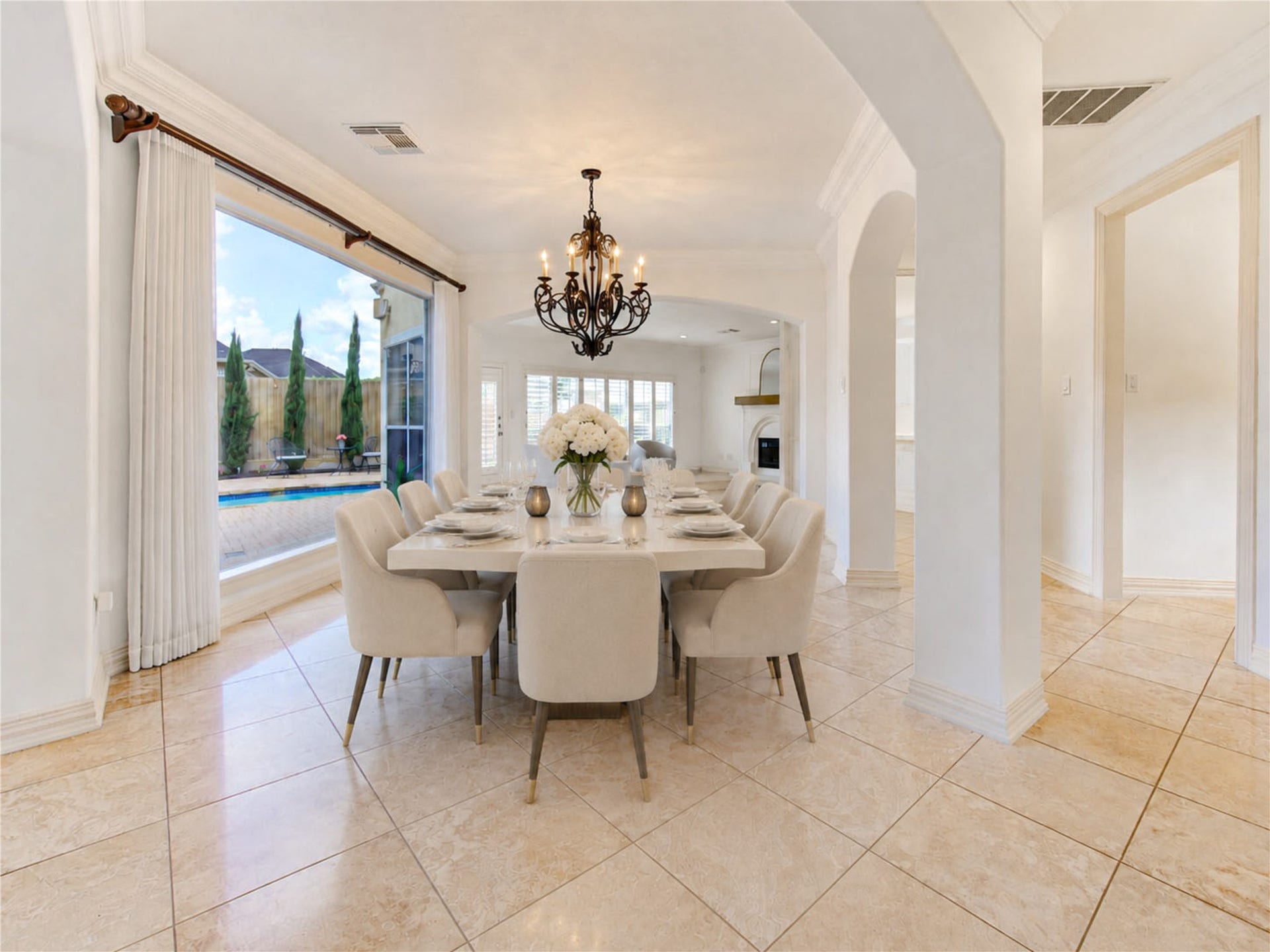 14114 Barnhart Boulevard, Houston, TX 77077 Formal dining room overlooking the pool; open layout flows seamlessly into the kitchen and living areas, perfect for entertaining.