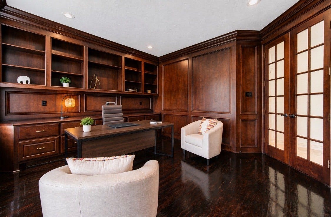 14114 Barnhart Boulevard, Houston, TX 77077 Custom wood-paneled study featuring floor-to-ceiling bookshelves, offering a quiet, private home office environment.
