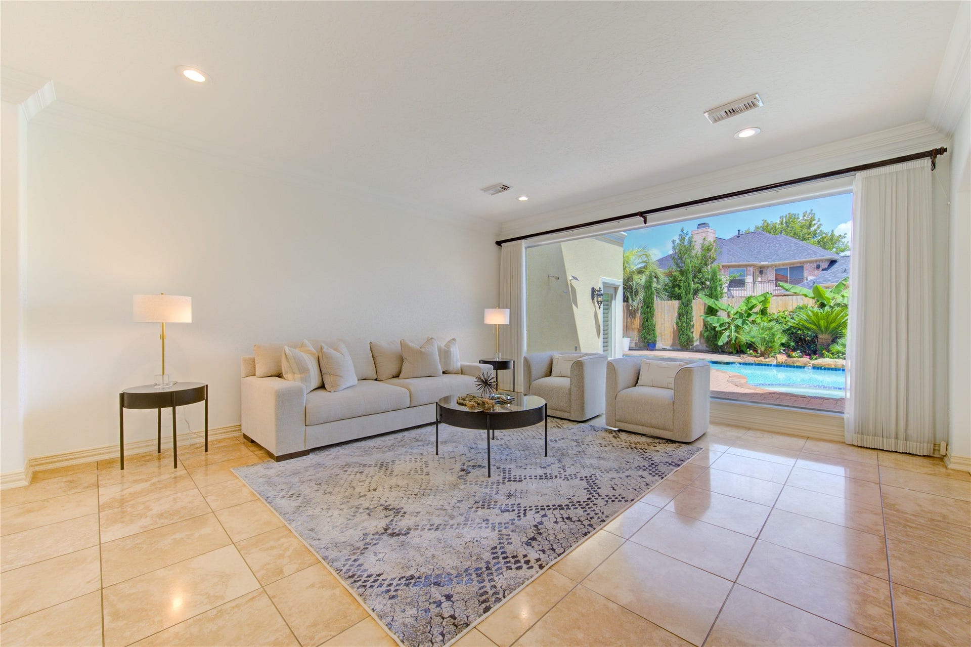14114 Barnhart Boulevard, Houston, TX 77077 Formal living room with expansive windows overlooking the pool and backyard.