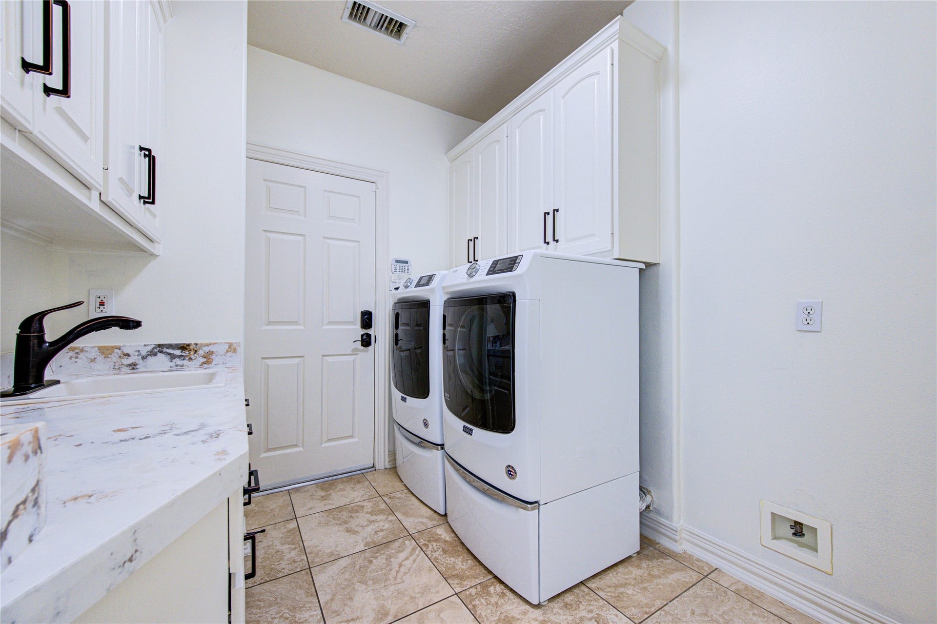 14114 Barnhart Boulevard, Houston, TX 77077 Laundry room includes all appliances. Direct access to a spacious 3-car garage with built-in cabinetry and ample storage space.