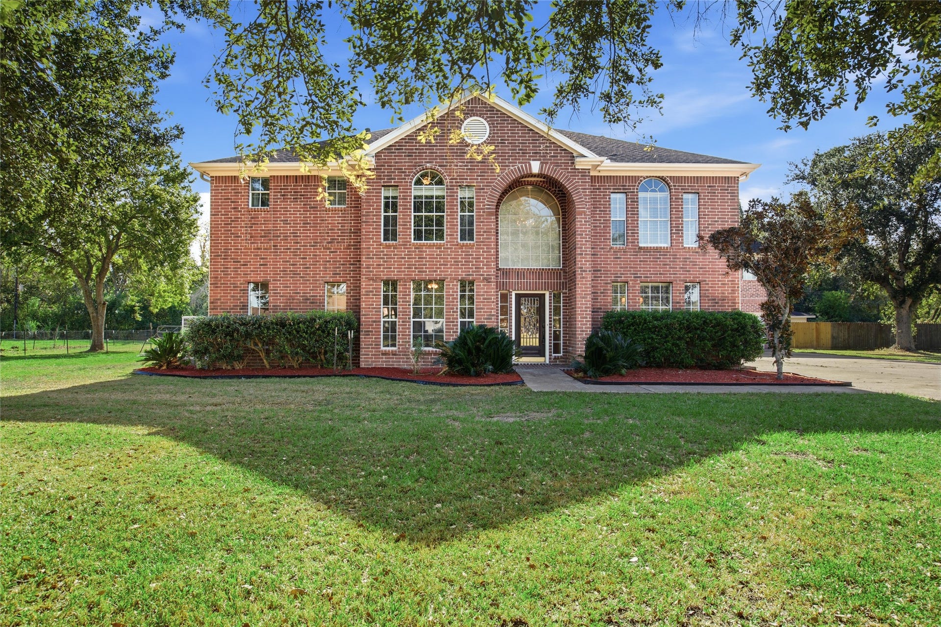 5202 W Zephyr Drive, #C378C, Alvin, TX 77511 Brick home on a one-acre lot with mature shade trees and a wide front lawn