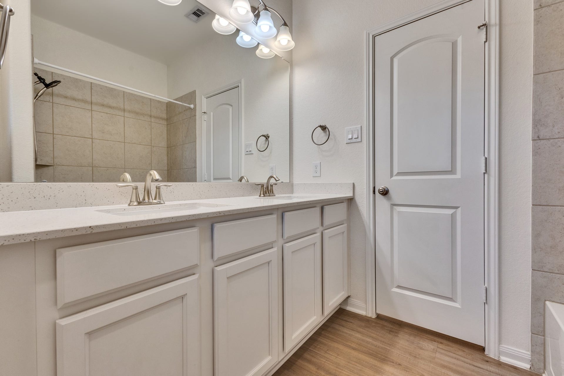 Hall Bath features dual sinks, shower/tub combo