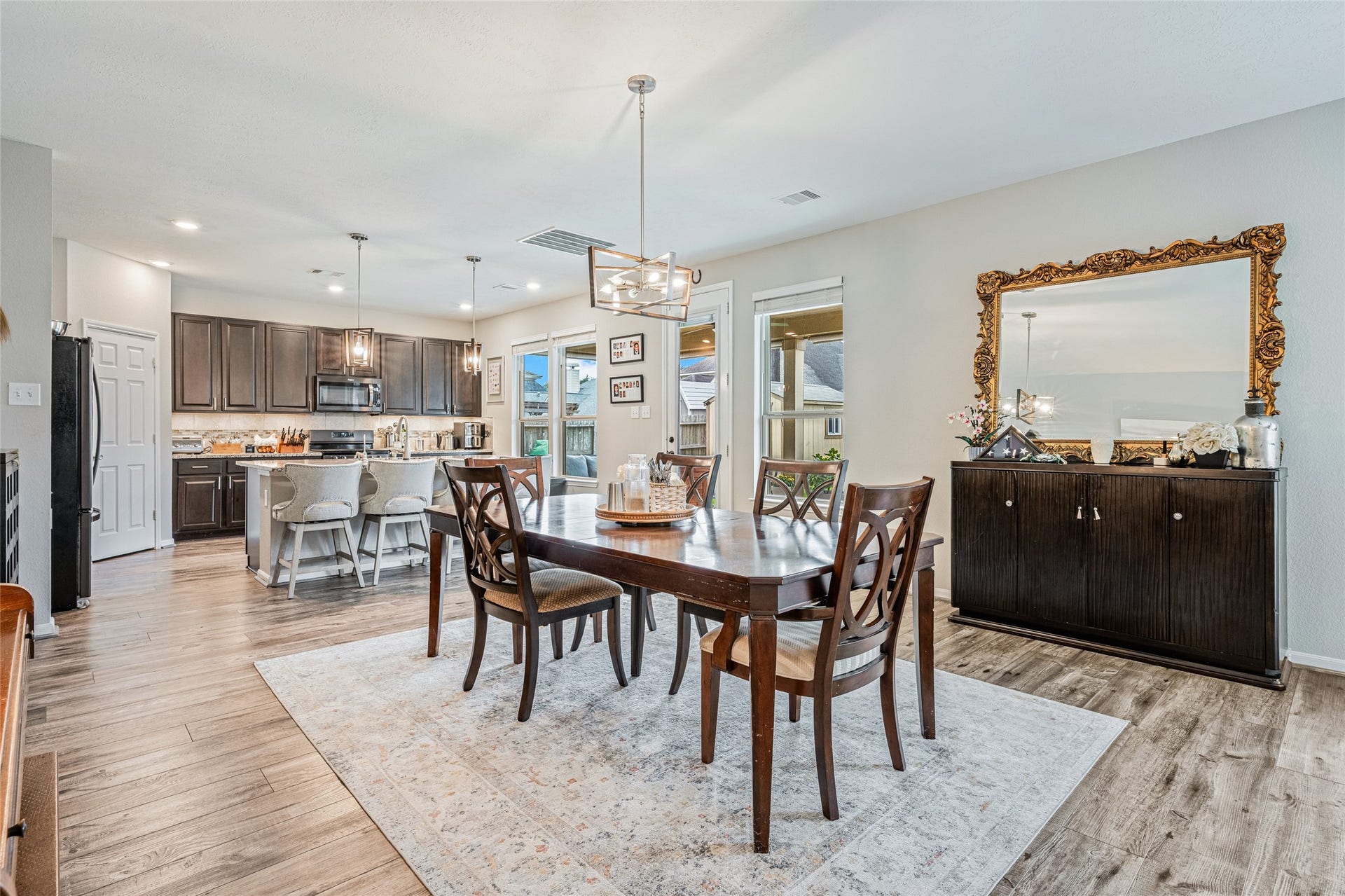 3806 Belmore Lane, Pearland, TX 77584 Dinner flows effortlessly from your kitchen to the adjoining dining area, giving you plenty of room to gather while keeping the entire main living space open and connected.
