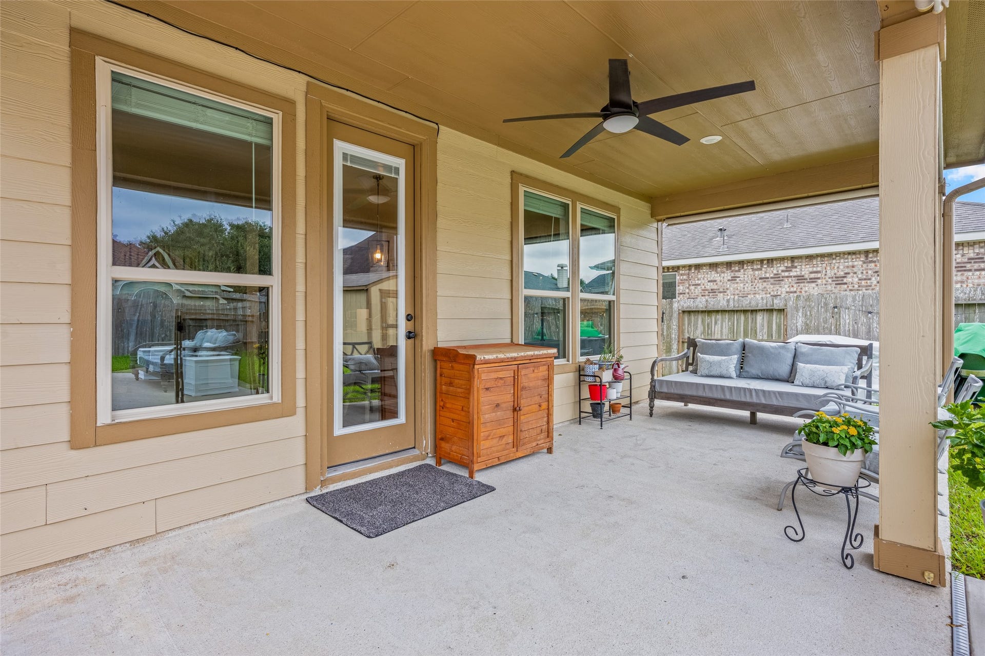 3806 Belmore Lane, Pearland, TX 77584 Relaxing outdoors is easy on your expansive covered patio, where ceiling fans and generous seating space create a comfortable extension of your living area.