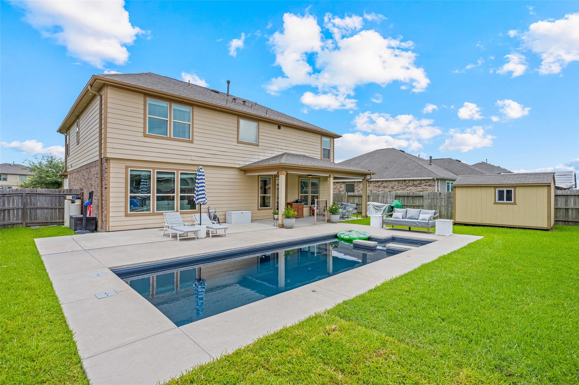 3806 Belmore Lane, Pearland, TX 77584 Step outside to your backyard retreat, where the pool, generous patio, covered seating area, and storage shed make outdoor living part of everyday life.
