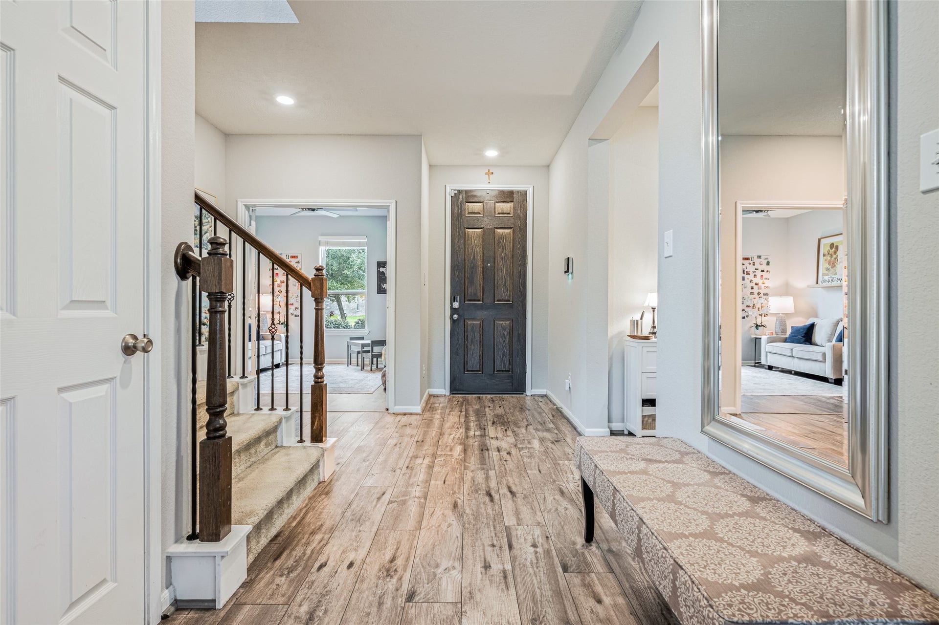 3806 Belmore Lane, Pearland, TX 77584 Coming home feels welcoming from the moment you step inside, with a bright entryway, warm wood-look flooring, and an open view toward the surrounding living spaces.
