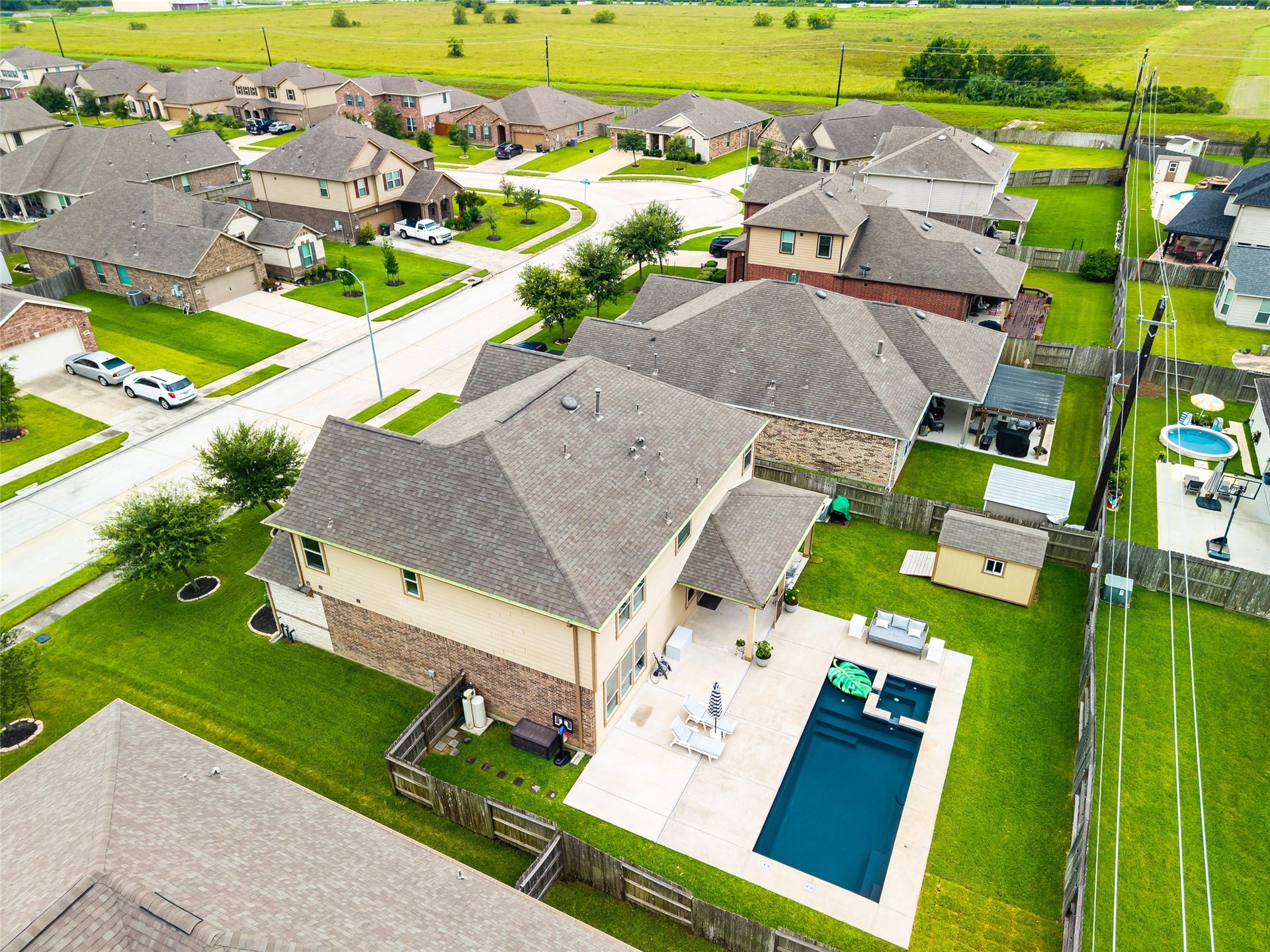 3806 Belmore Lane, Pearland, TX 77584 Your backyard feels like a private getaway, with a sparkling pool, attached hot tub, spacious patio, and plenty of lawn for enjoying time outdoors.
