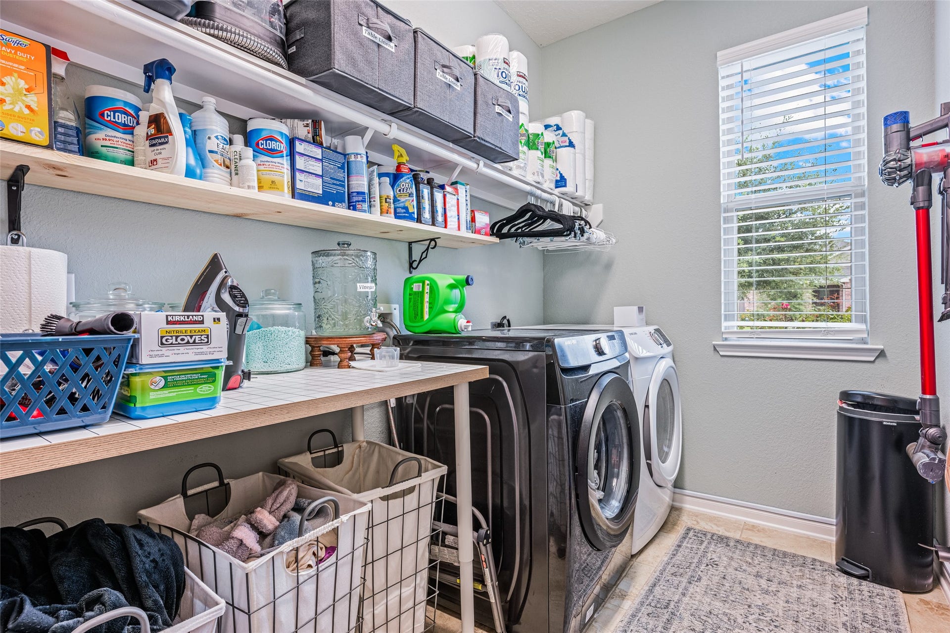 3806 Belmore Lane, Pearland, TX 77584 Laundry days stay organized with a dedicated utility room offering shelving, hanging space, a work surface, and natural light.