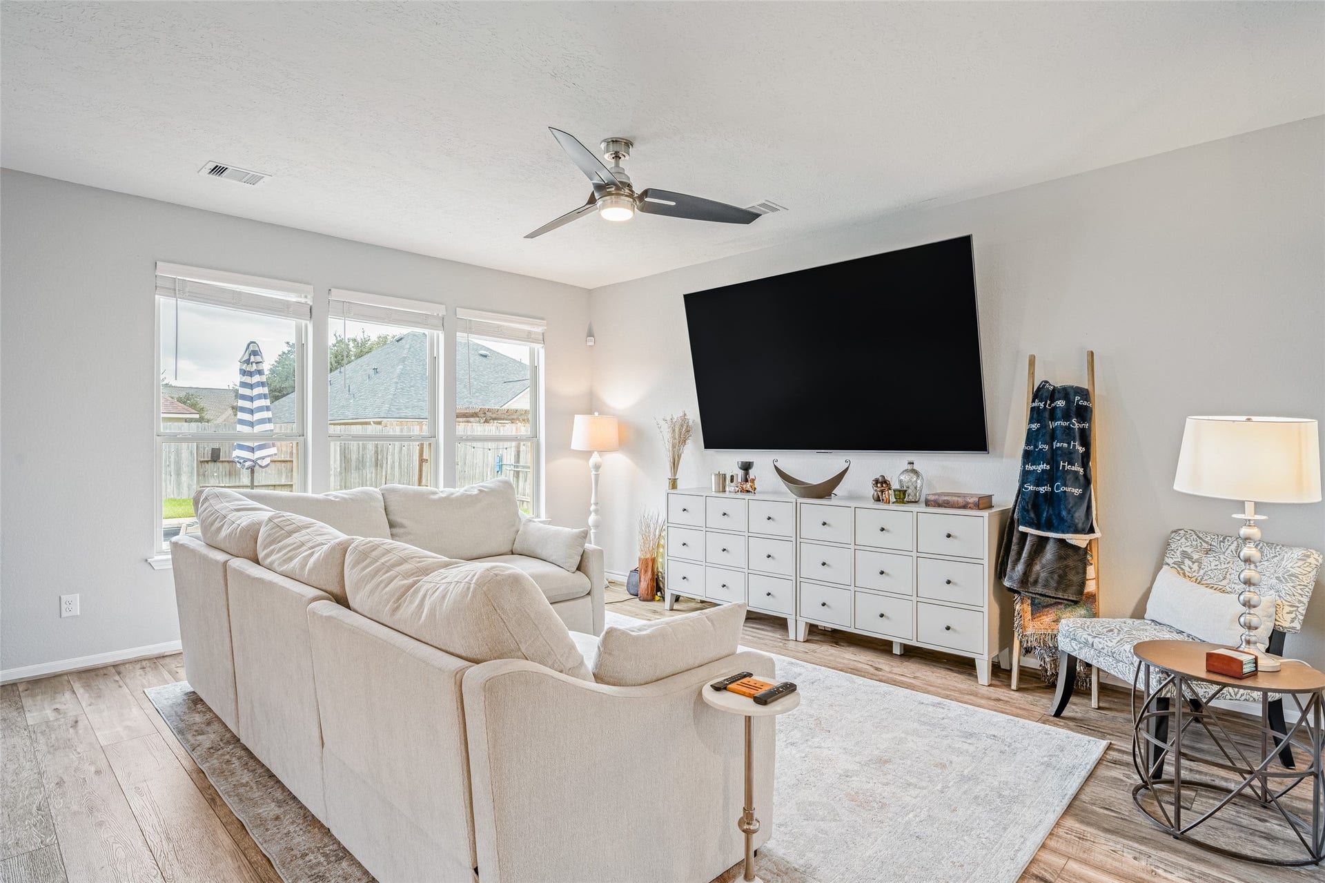 3806 Belmore Lane, Pearland, TX 77584 Kick back and settle in for movie nights in your bright living room, where a generous seating area and multiple windows create a comfortable place to unwind.