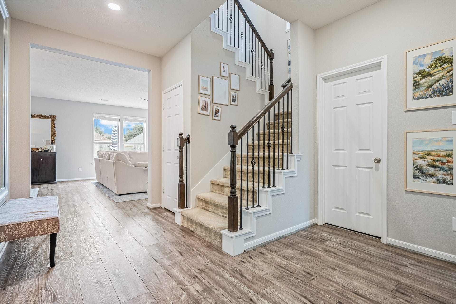 3806 Belmore Lane, Pearland, TX 77584 Moving through your entryway feels open and inviting, with warm wood-look flooring and a staircase that adds character while connecting the main living spaces.