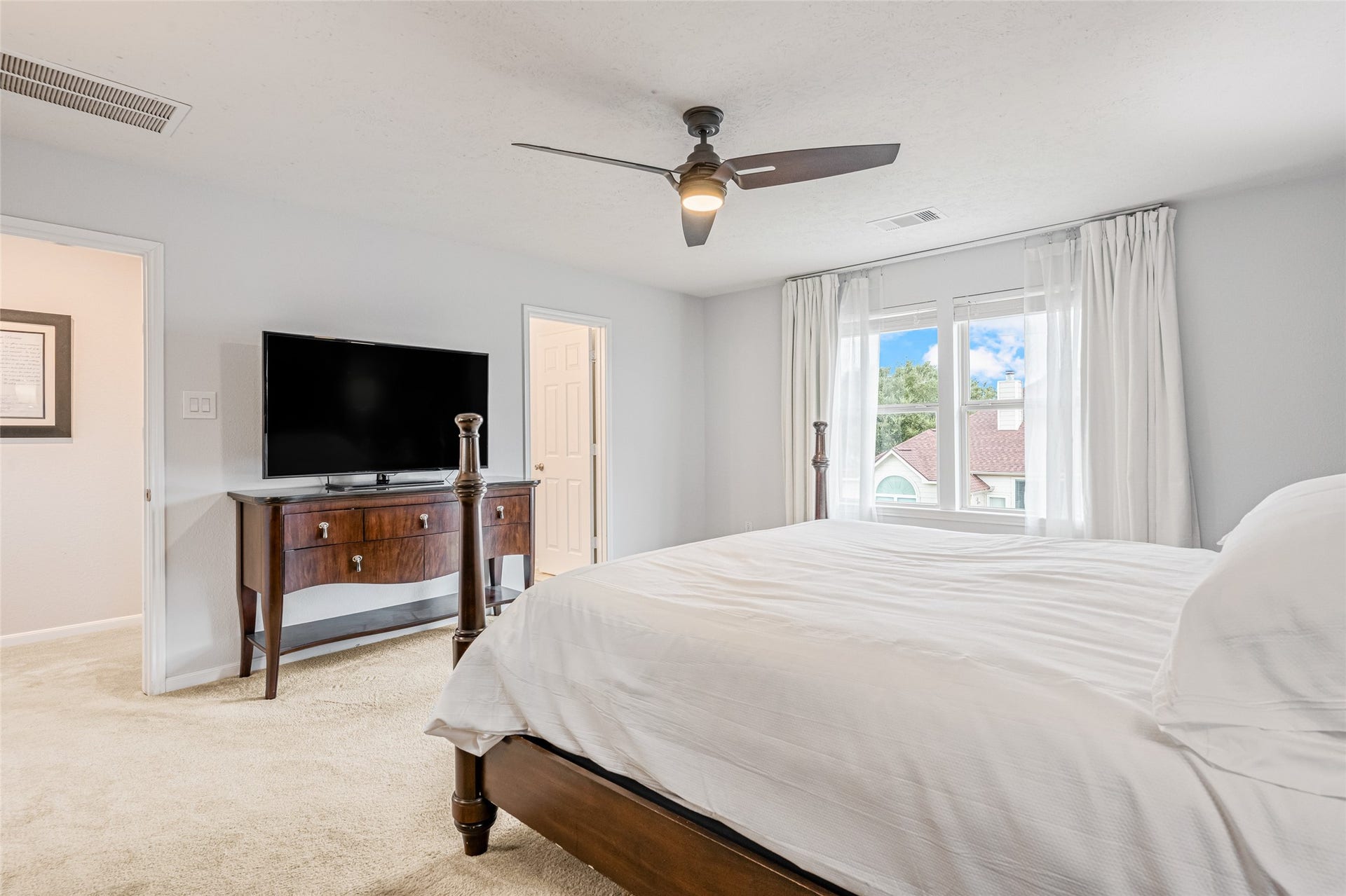 3806 Belmore Lane, Pearland, TX 77584 Waking up feels easy in your spacious primary bedroom, where soft natural light, a ceiling fan, and a calming neutral palette create a restful retreat.