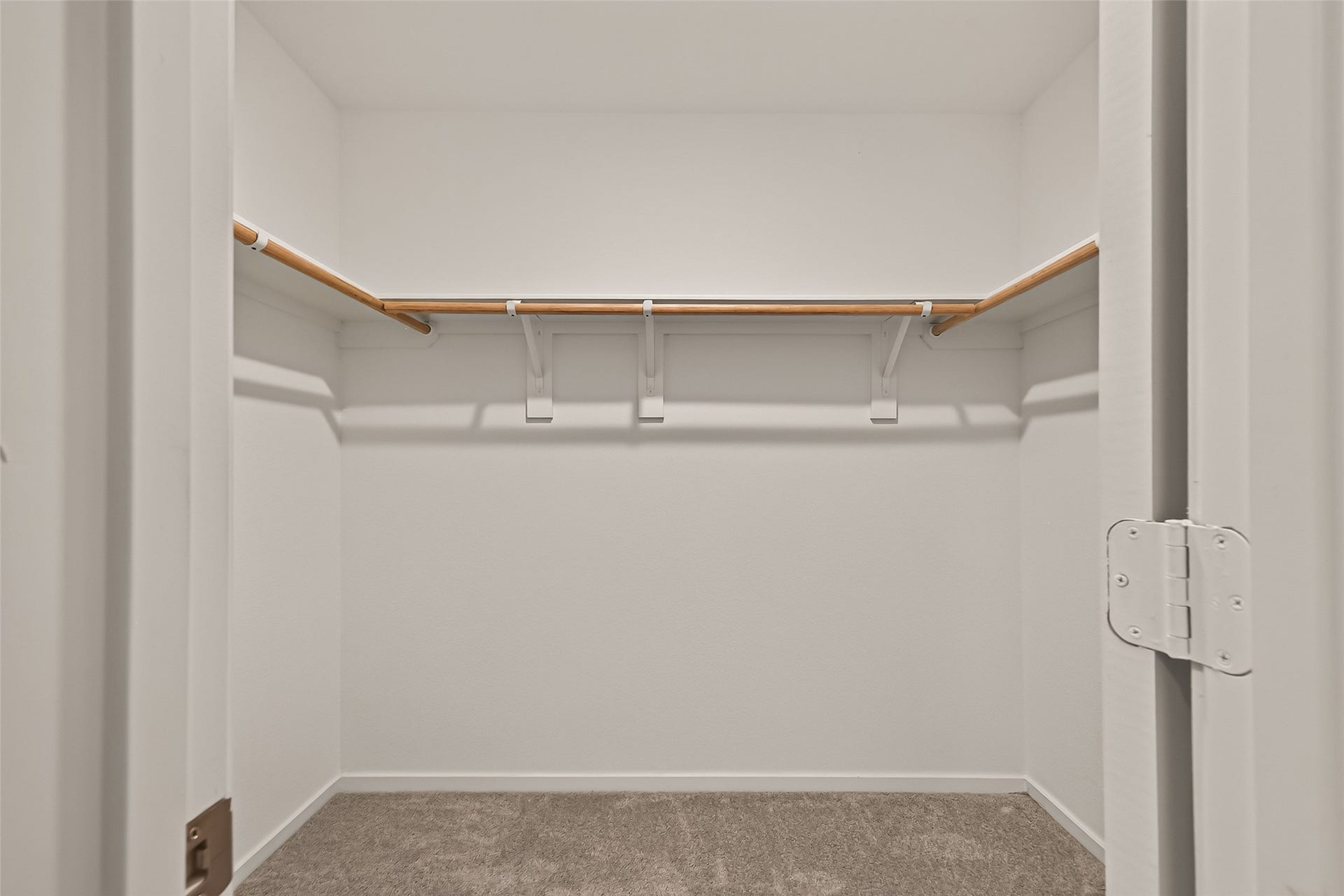 7814 Lavender Jade Drive, Rosharon, TX 77583 The primary walk-in closet is exceptionally spacious, featuring built-in racks and storage shelving, accessible via double doors.