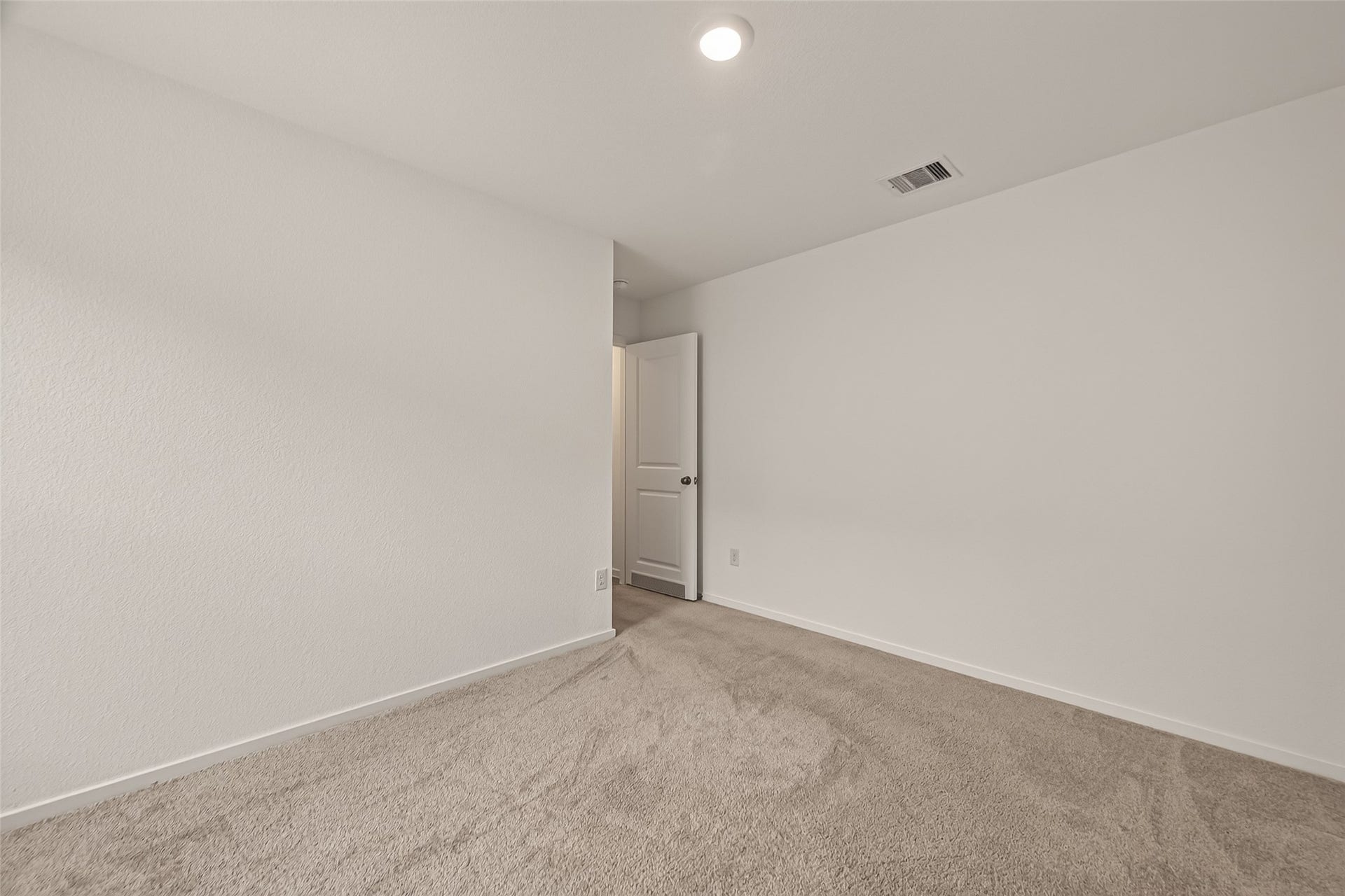 7814 Lavender Jade Drive, Rosharon, TX 77583 view 2 of the Spacious first secondary bedroom featuring abundant natural light and a versatile layout.
