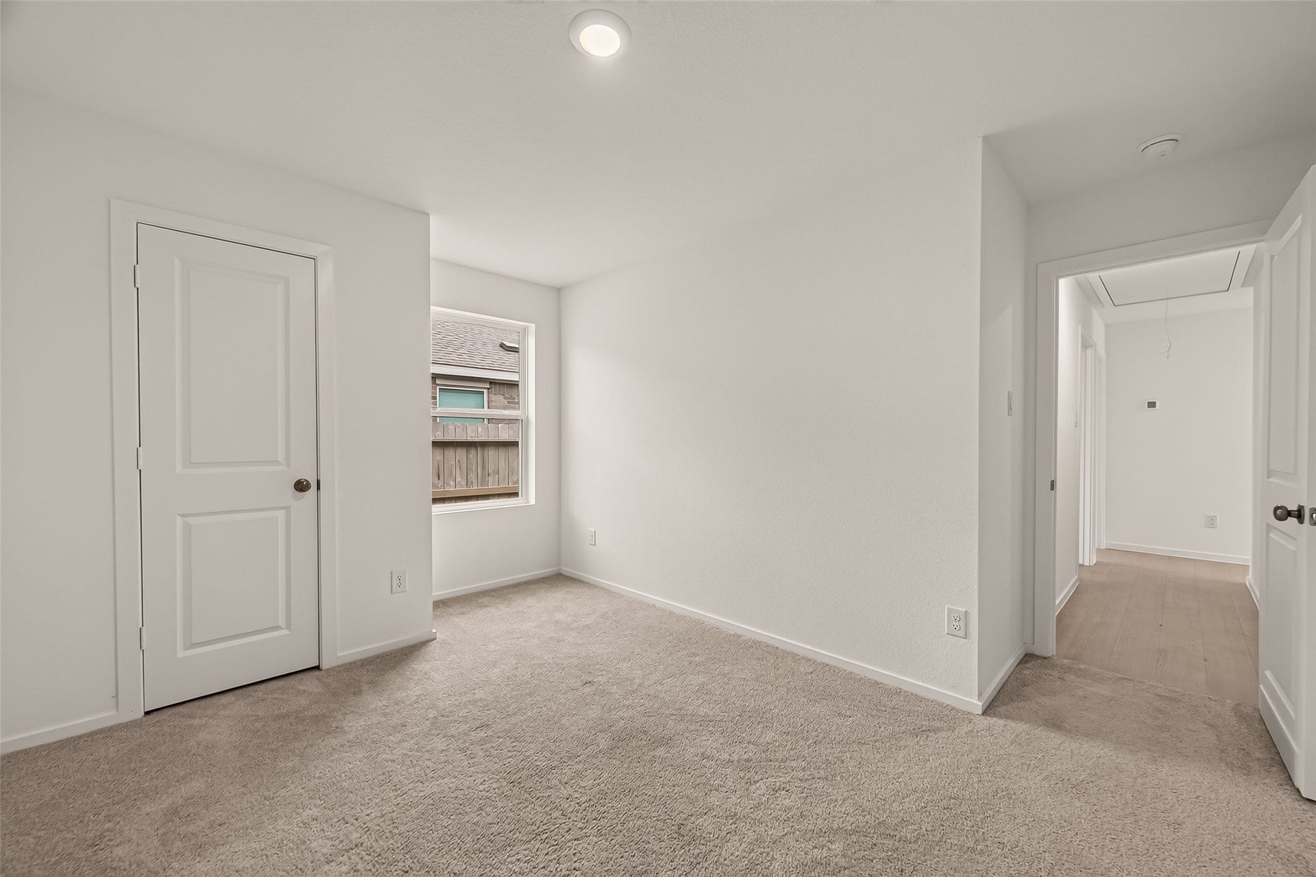 7814 Lavender Jade Drive, Rosharon, TX 77583 1st Secondary bedroom located at the front of the home featuring an oversized window for abundant natural light. This spacious room includes a large closet and pristine, like-new carpeting.
