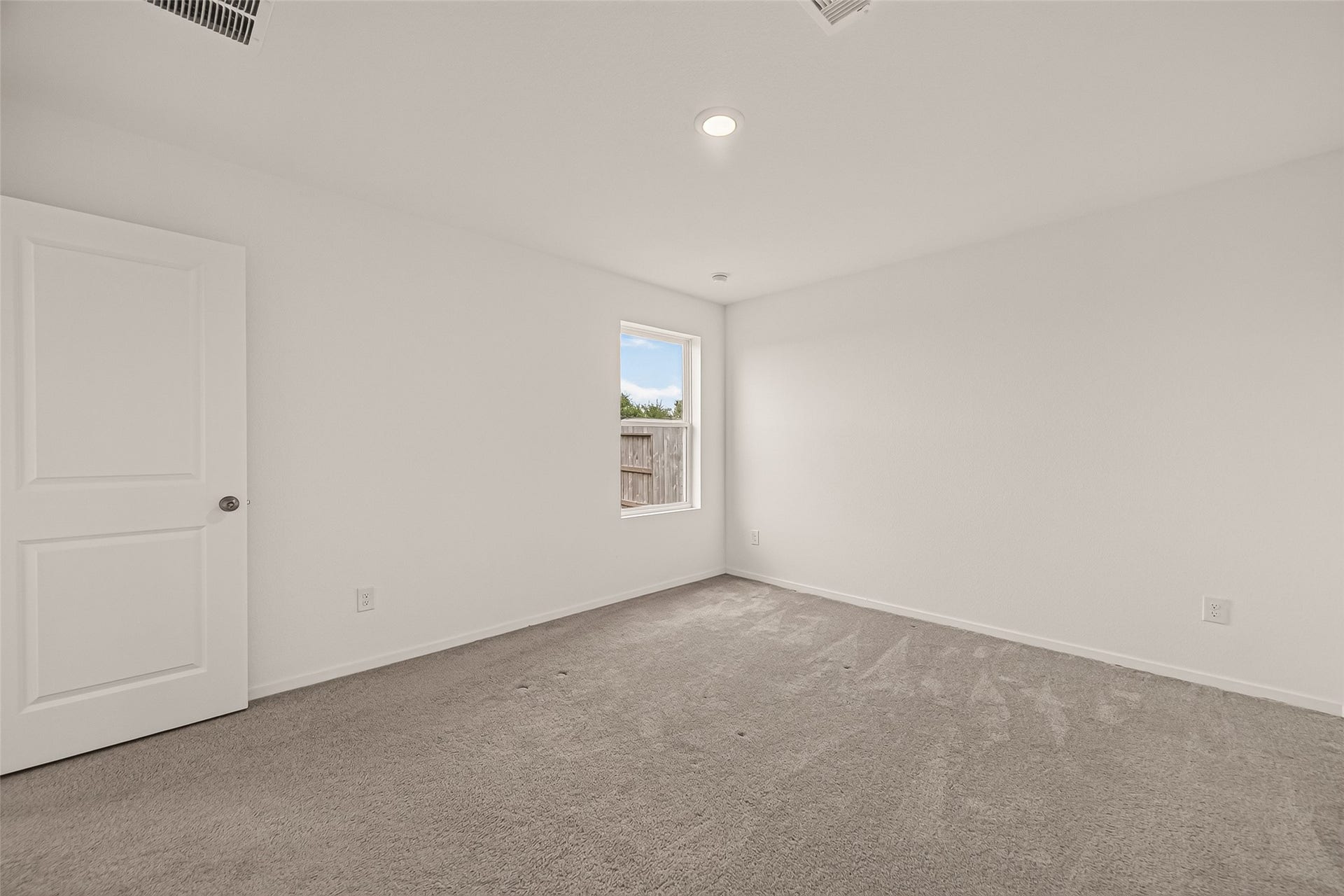 7814 Lavender Jade Drive, Rosharon, TX 77583 The primary bedroom is situated at the rear of the home, offering a spacious and private retreat with views overlooking the backyard.