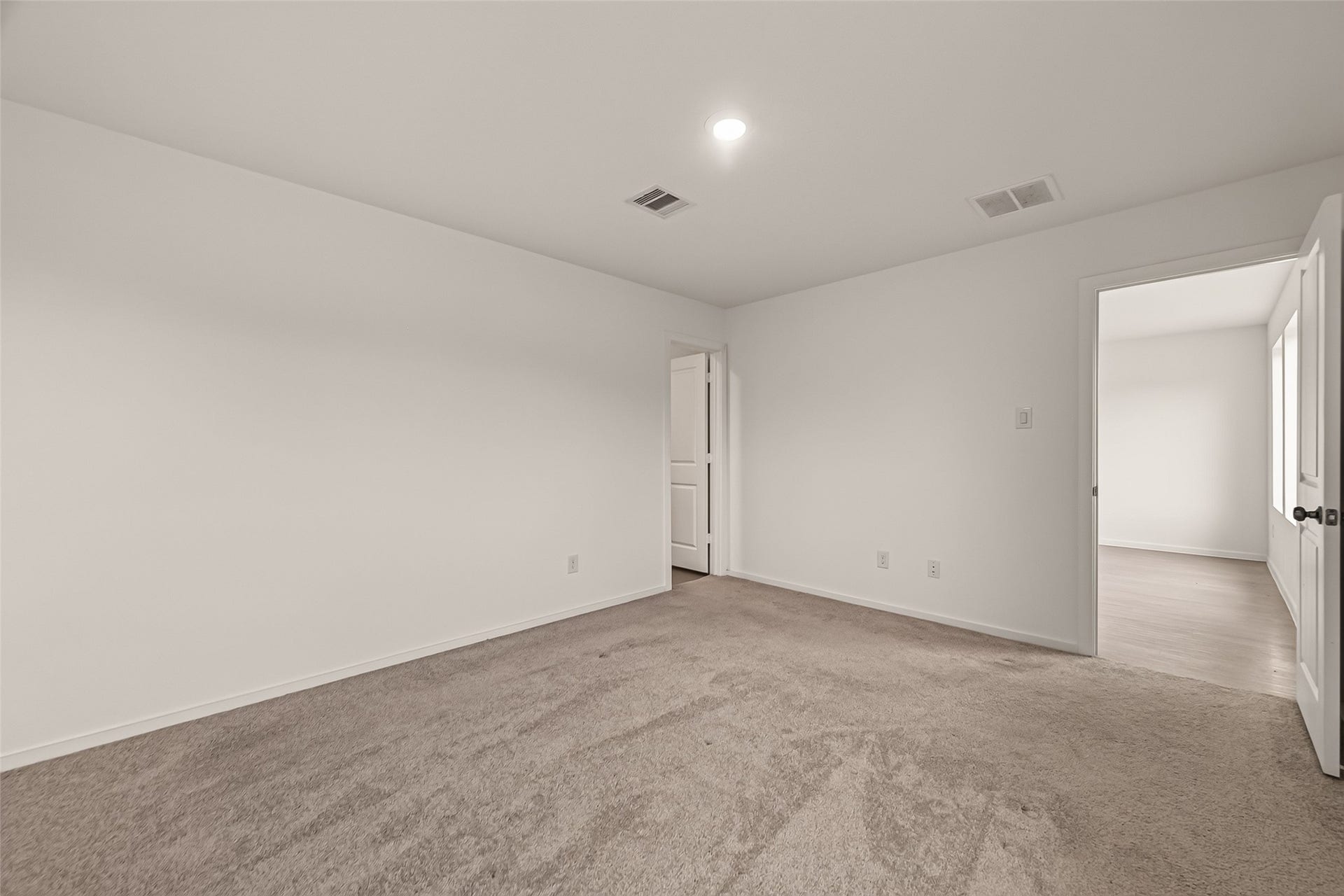 7814 Lavender Jade Drive, Rosharon, TX 77583 This photograph displays the entrance to the primary bath and walk in closet
