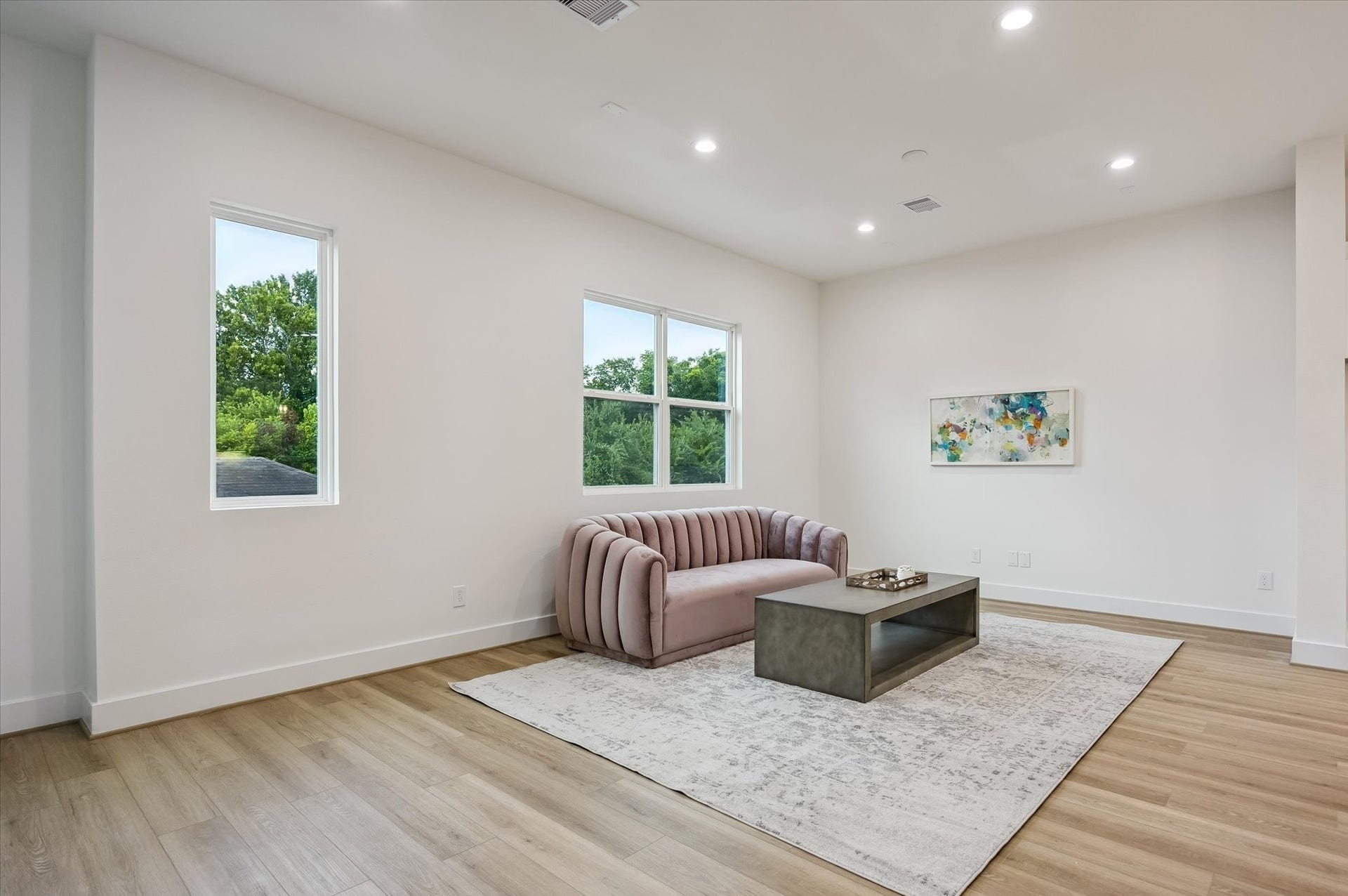 The expansive living room offers an inviting space to gather, entertain, or simply relax in style.
