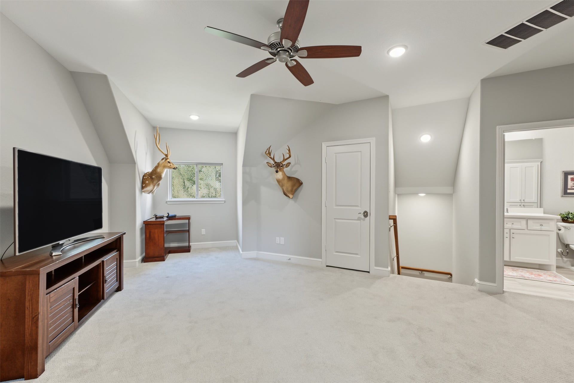 501 Corsair Court, Montgomery, TX 77316 Up the hallway stairs from the utility room is the gameroom or extra living space for the upstairs bedroom.