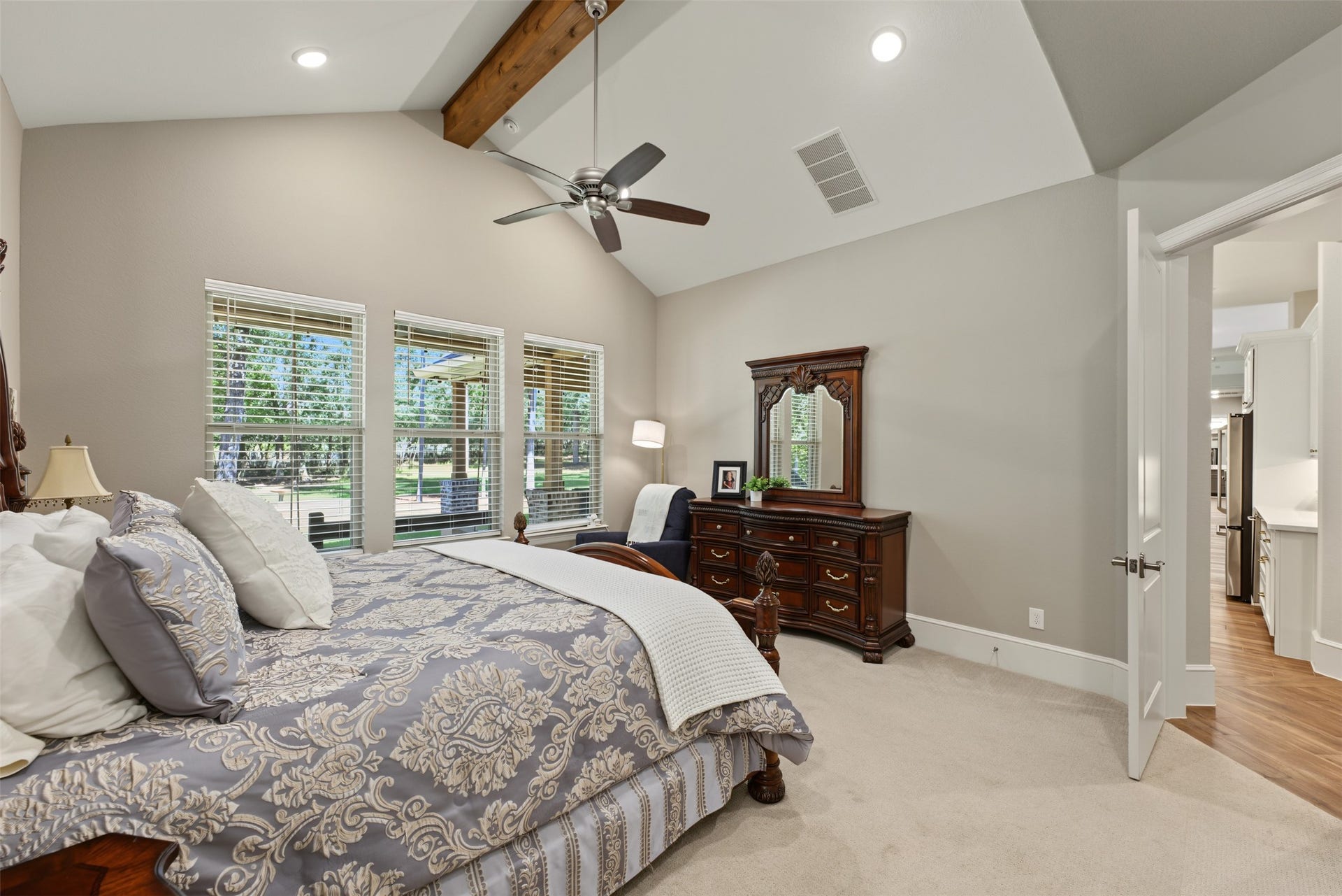 501 Corsair Court, Montgomery, TX 77316 Just past the kitchen is the primary suite with cedar wrapped beam and views of the back yard.