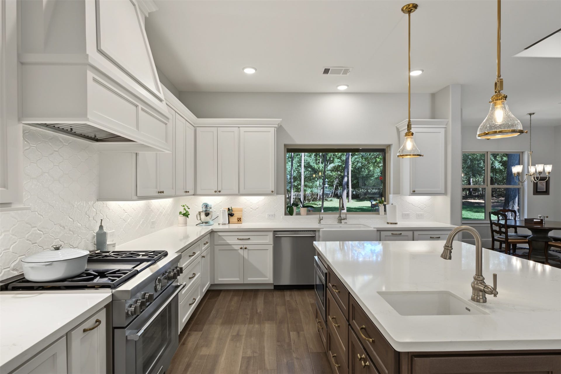 501 Corsair Court, Montgomery, TX 77316 Kitchen features white oak island with handwashing sink and upgraded cabinetry. More upgrades include the Thermador dual fuel range.